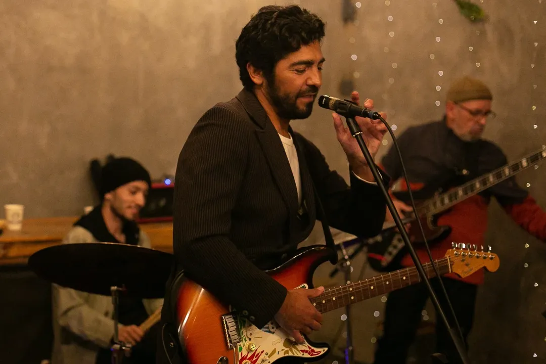 A yellow tram on tracks in a narrow city street.