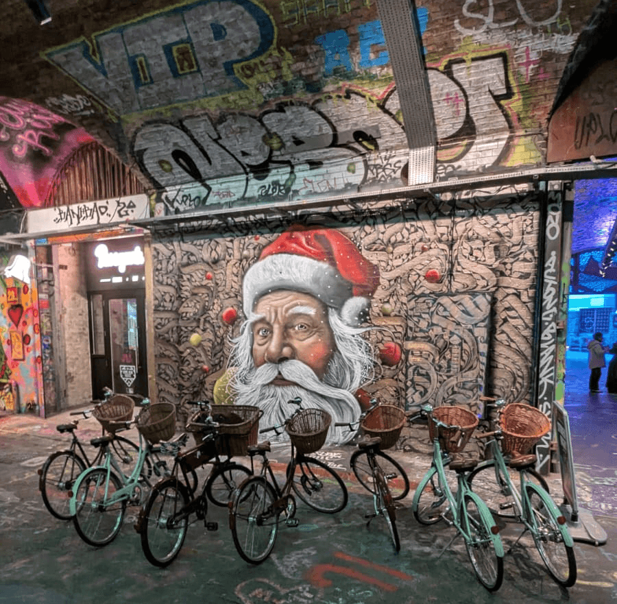 Santa Street art in the Banksy Tunnel on a Tally Ho London bike tour 