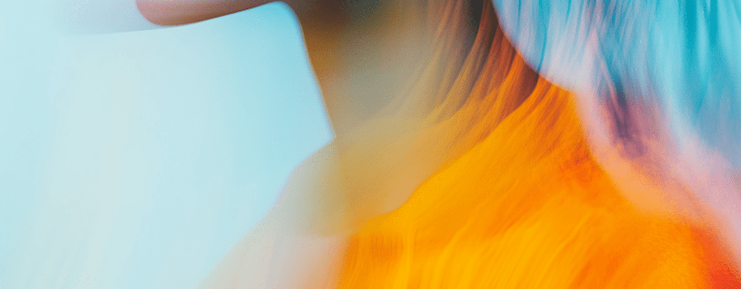 Artistic profile portrait of a woman with ethereal motion blur in orange and teal tones.