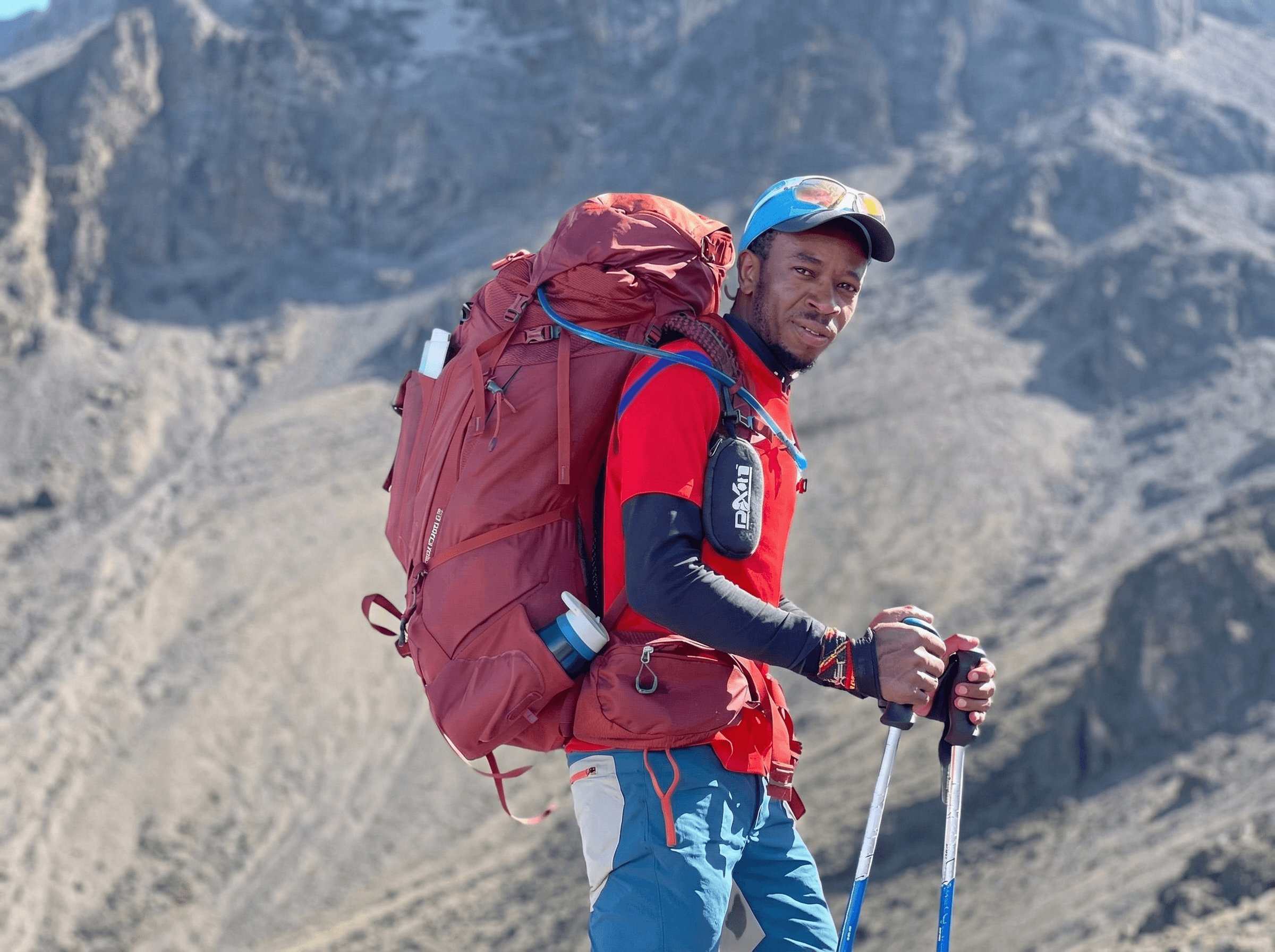 Portrait of Amir Al-Qatifi, founder and lead guide of AlUla desert tours, standing under desert sunlight.