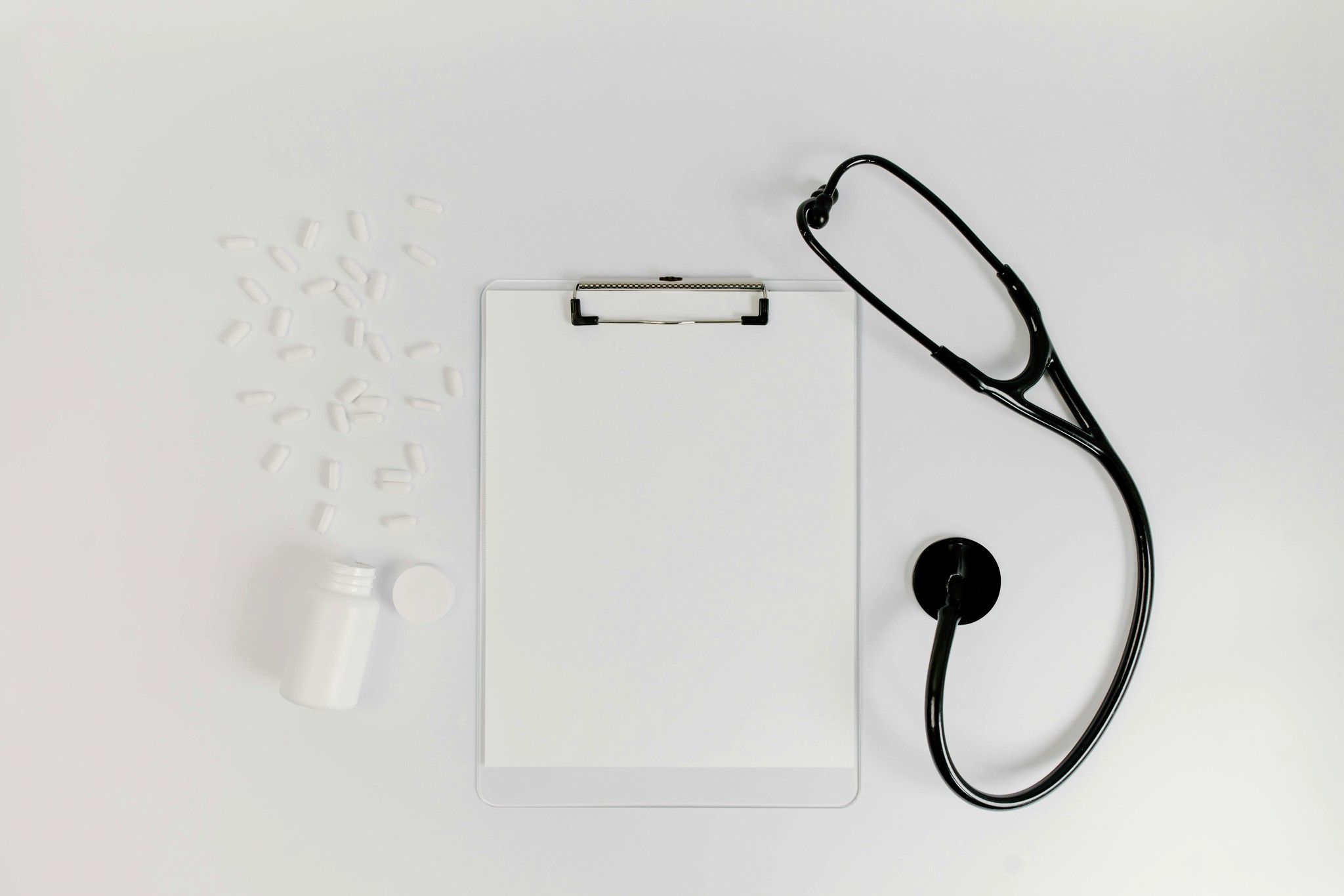 Clipboard, stethescope, and a pill bottle.