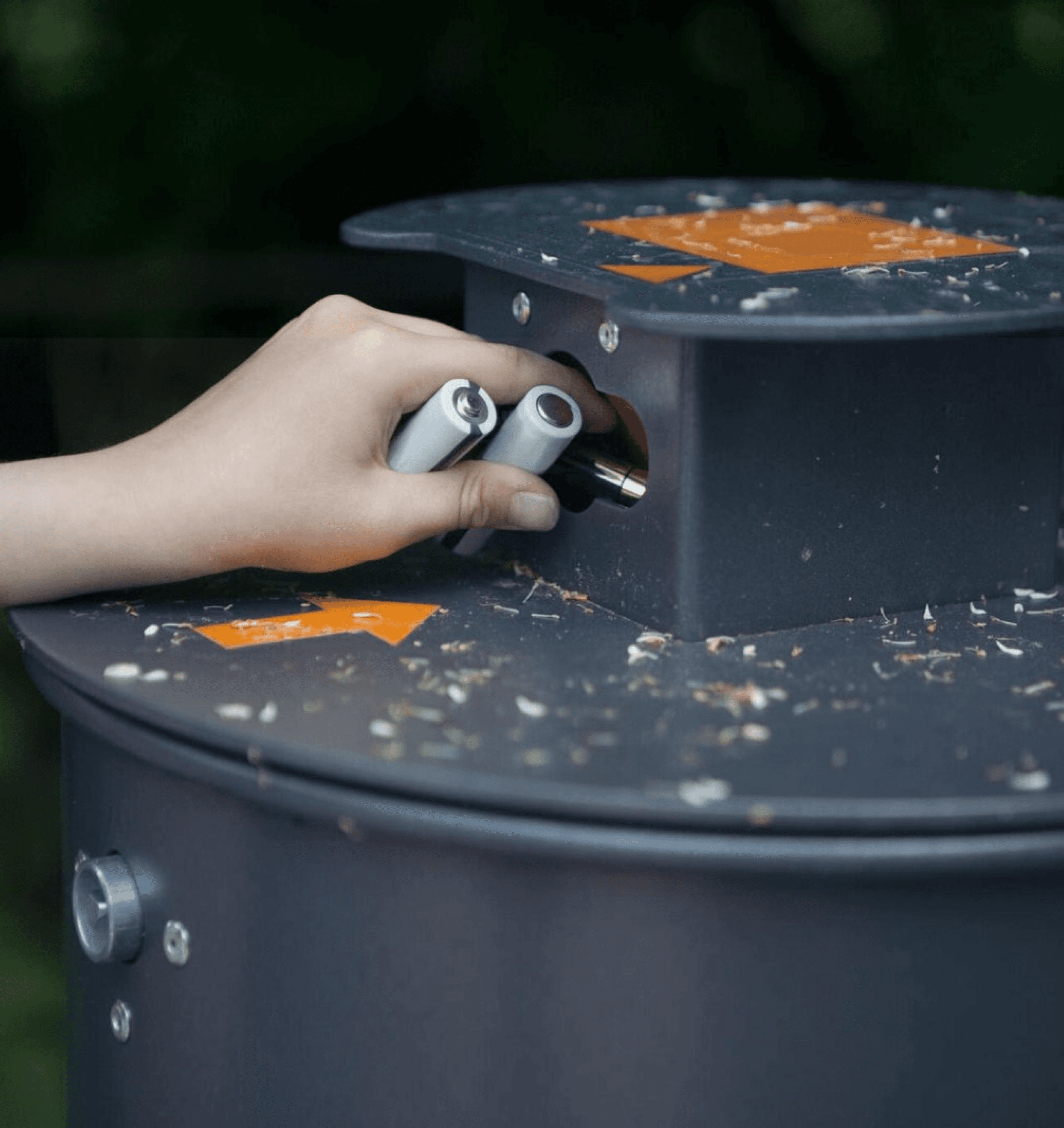 man Putting battery in Recycling dustbin