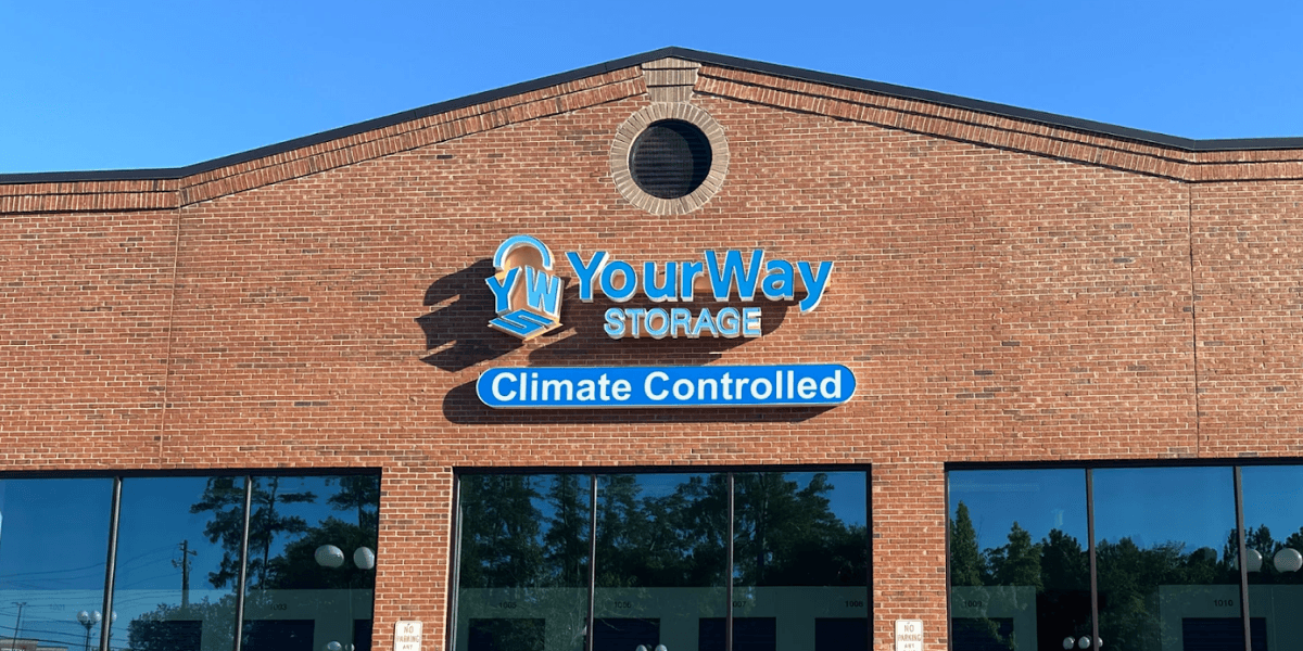 The image shows the "YourWay Storage" building with a blue logo, highlighting the "Climate Controlled" feature, located in Augusta, GA.
