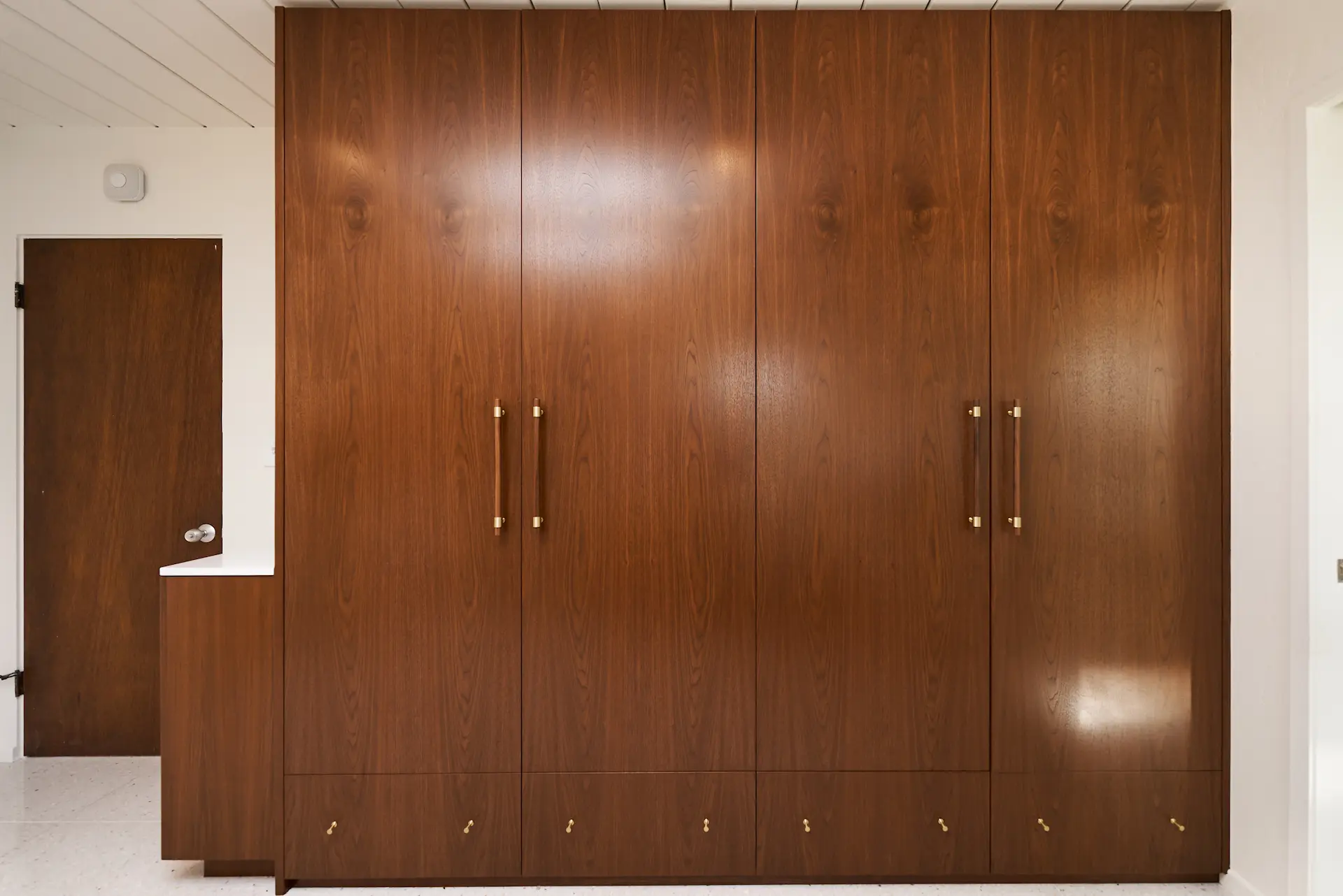 Wide view of the wardrobe cabinetry in the primary bedroom, showcasing storage solutions and design in the Fairhaven Eichler Tract remodel. Photo by Todd Huge.