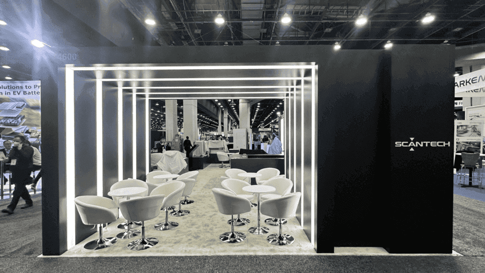 Technical product booth with product displays, process graphics, meeting space, and structured visitor flow