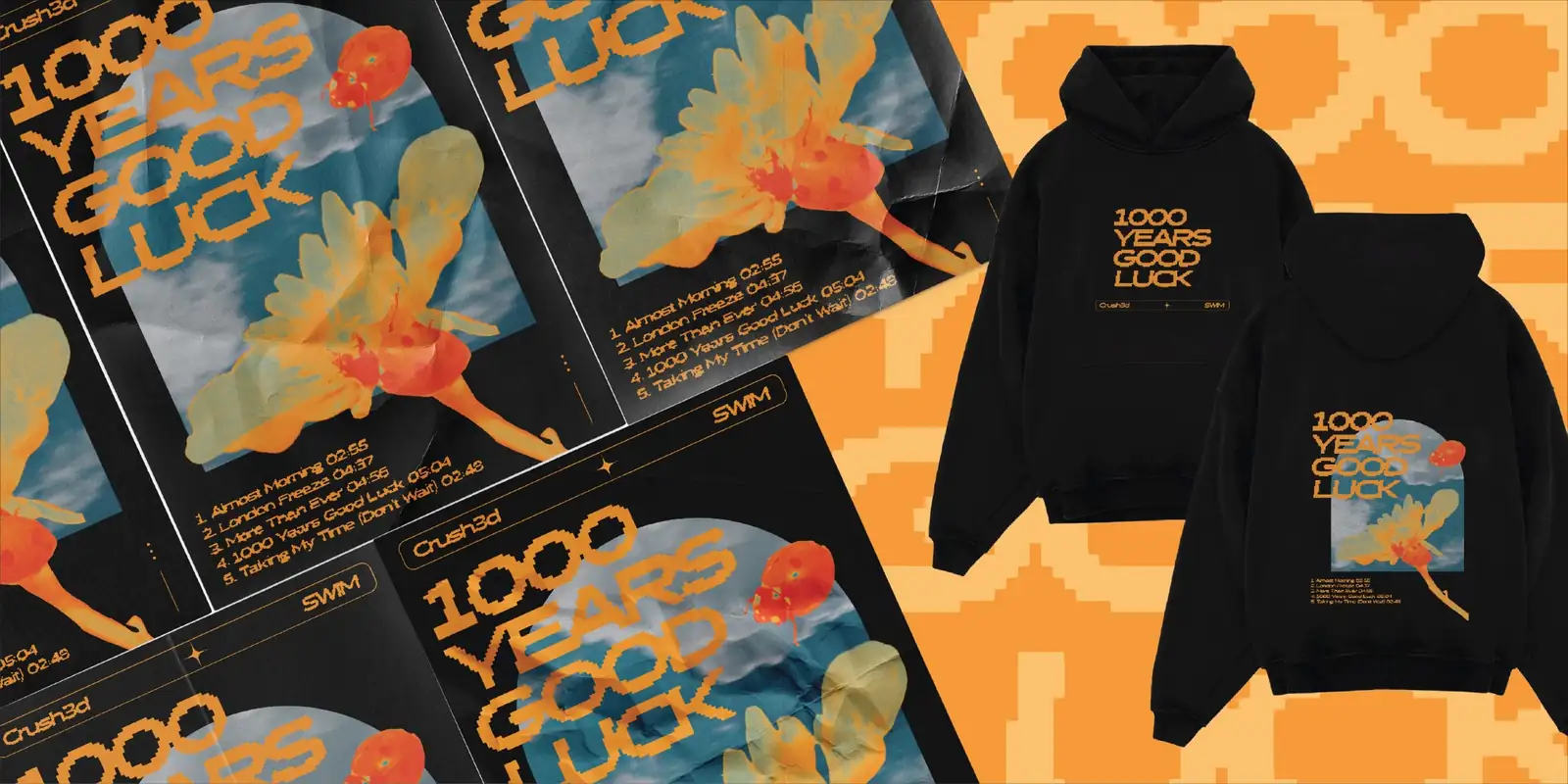 Orange and blue floral posters reading 1000 years of good luck, beside a black hoodie with the same print front and back
