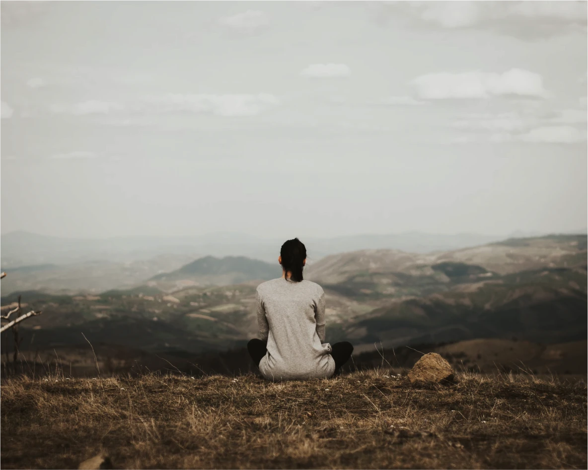 The back of a woman looking out into nature