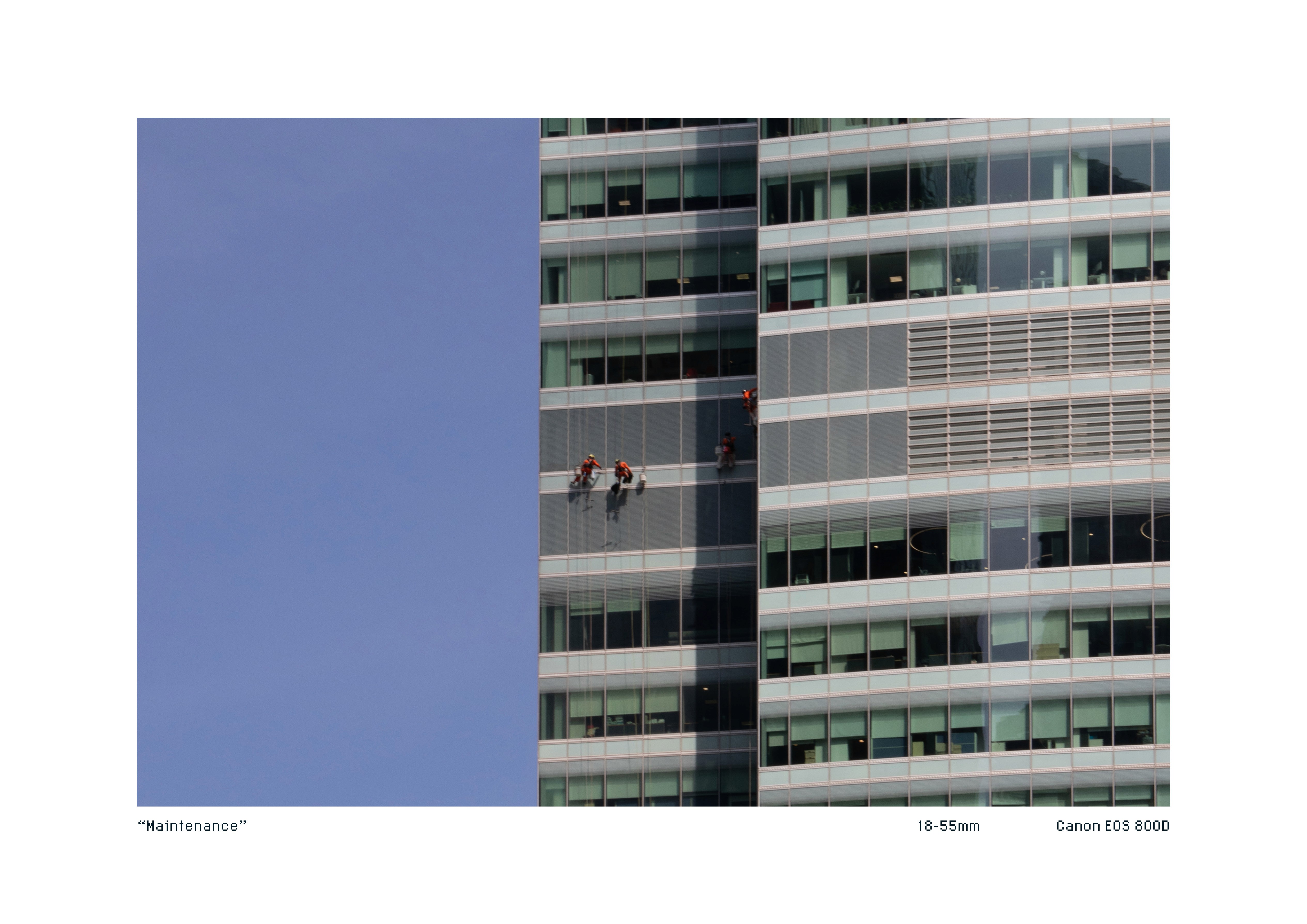 Telephoto shot of maintenance and cleaning workers on the side of a high rise building