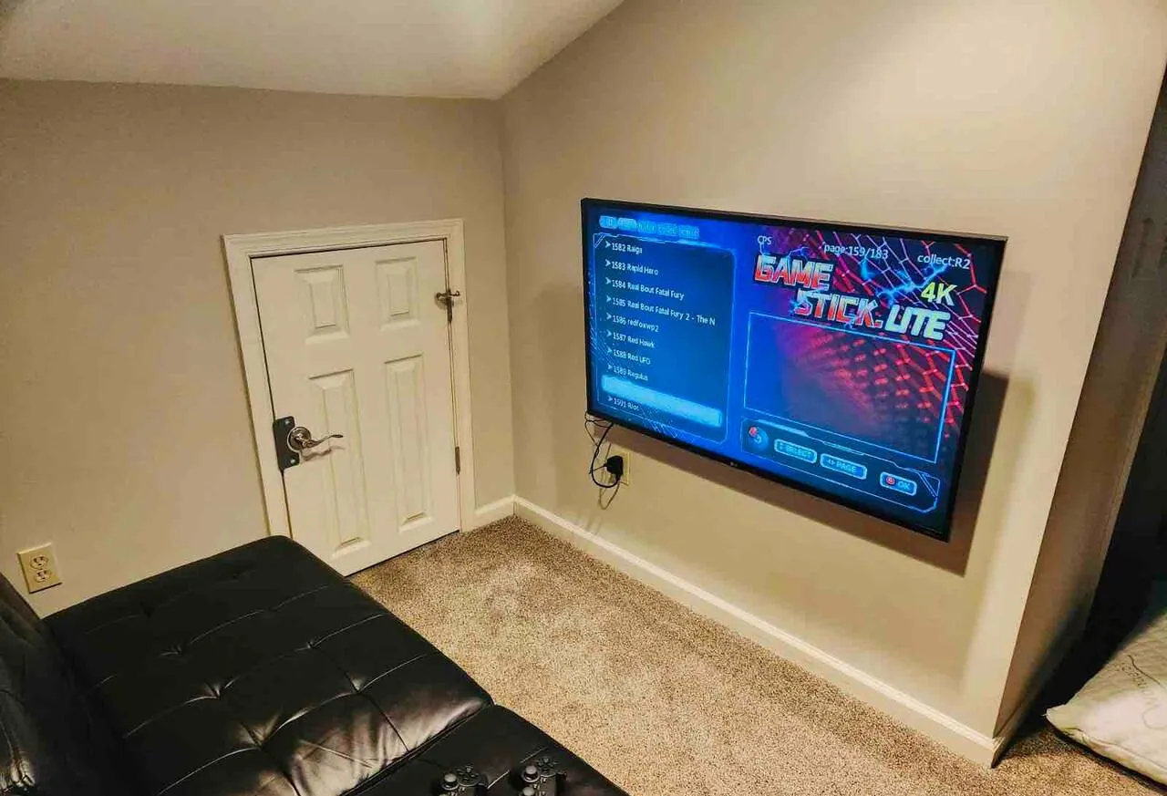 Loft with leather futon and wall TV showing an arcade game menu at SummitWind