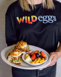 Wild Eggs team member serving scratch-made breakfast and brunch