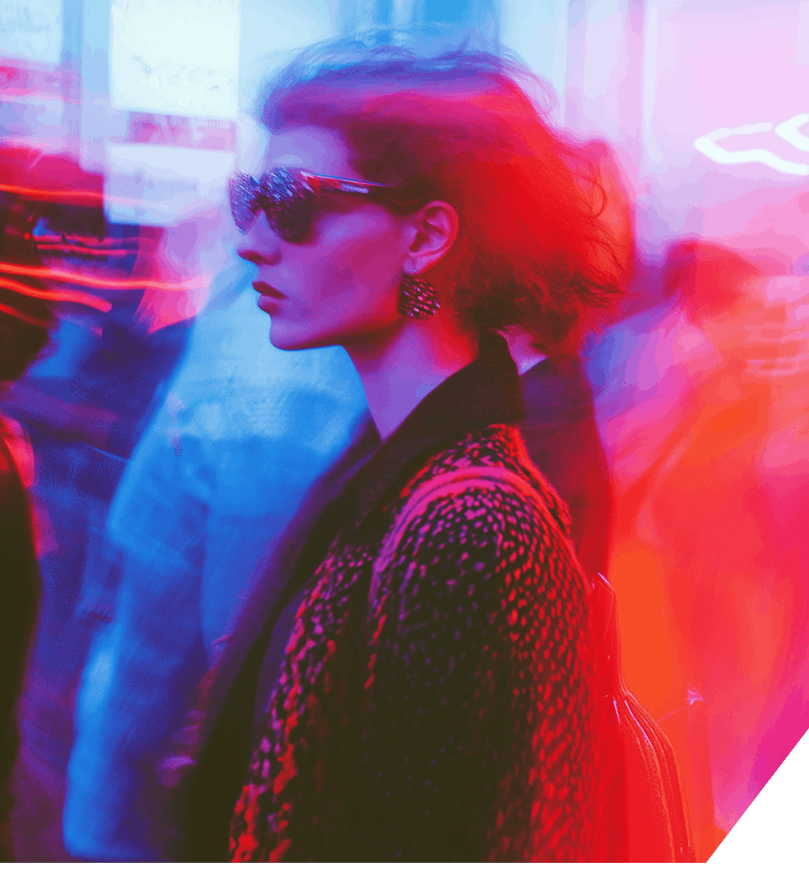 A hazy scene depicting several individuals strolling down a street, emphasizing the bustling atmosphere of the area.