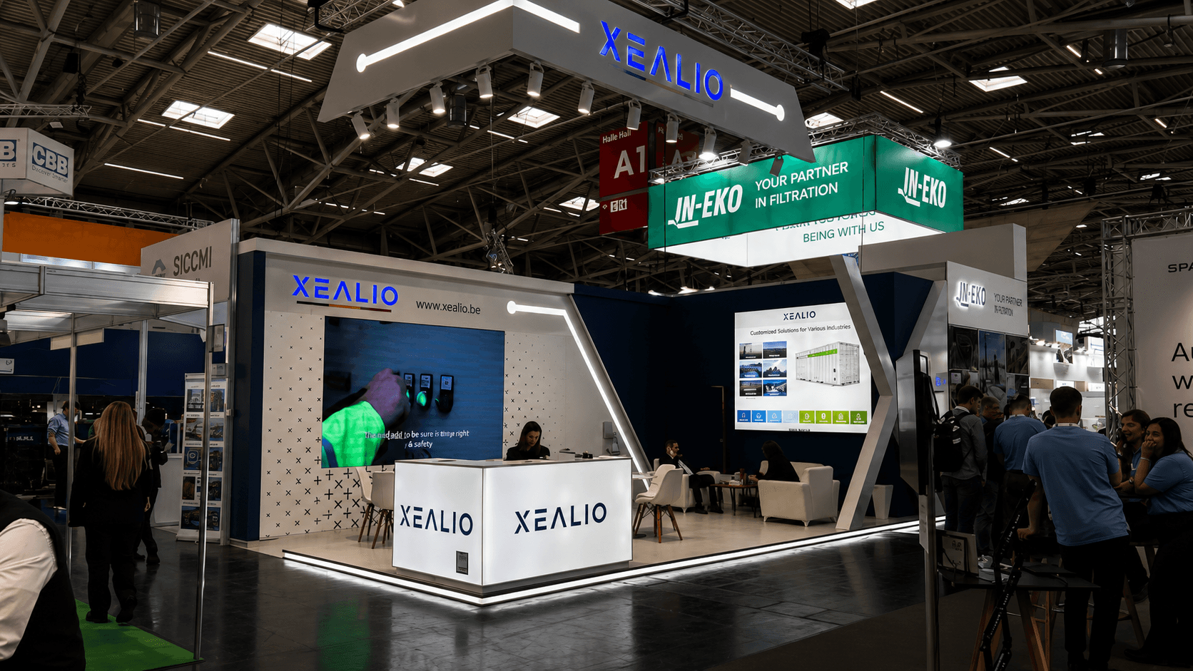 Xealio exhibition stand at IFAT 2026 Munich, featuring a large X-shaped architectural frame reflecting the company's logo and brand identity, with a clean blue and white colour palette.