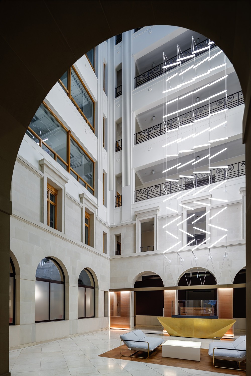 Suspended lighting installation in Brindley Place atrium featuring 60 custom acrylic LED units in a zig-zag formation