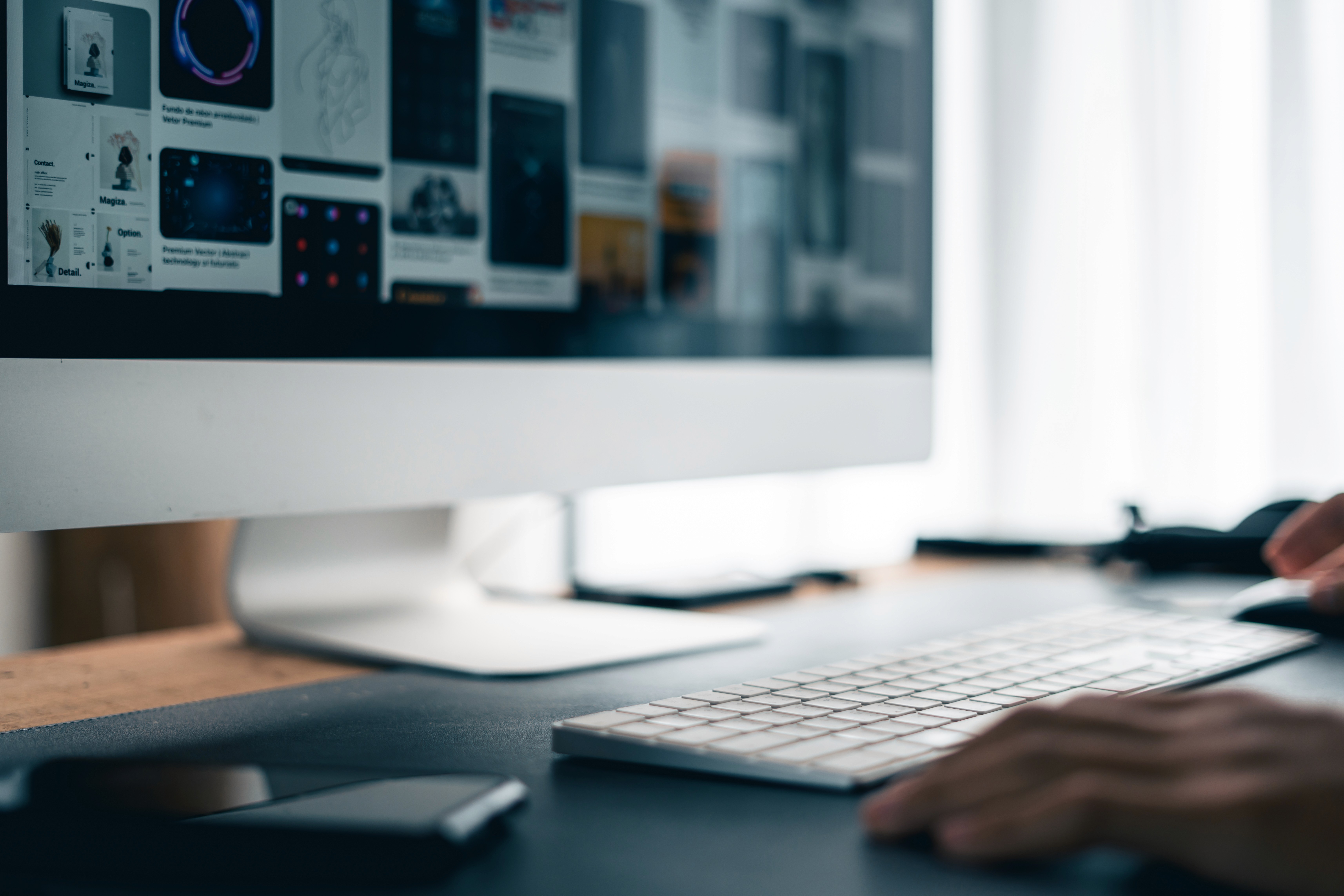 Man working on Portfolio at desk using desging strategy.