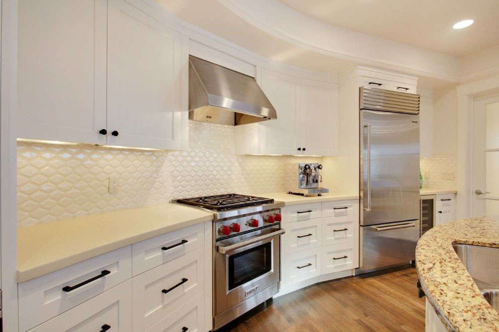 Image of Luxury kitchen design with white cabinets, stainless steel appliances, and elegant layout by KHD Homes.
