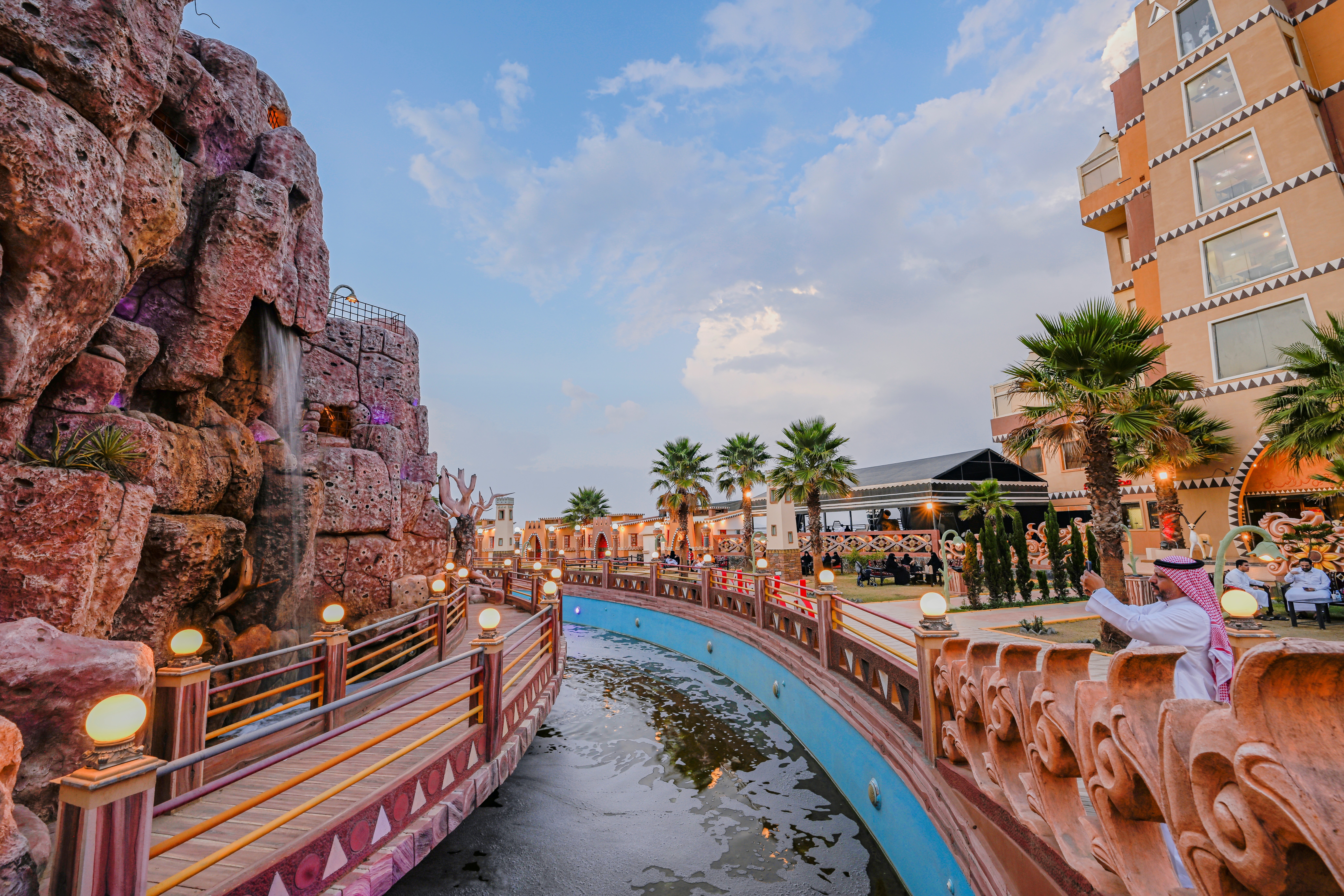 woman in blue tank top standing beside white wall