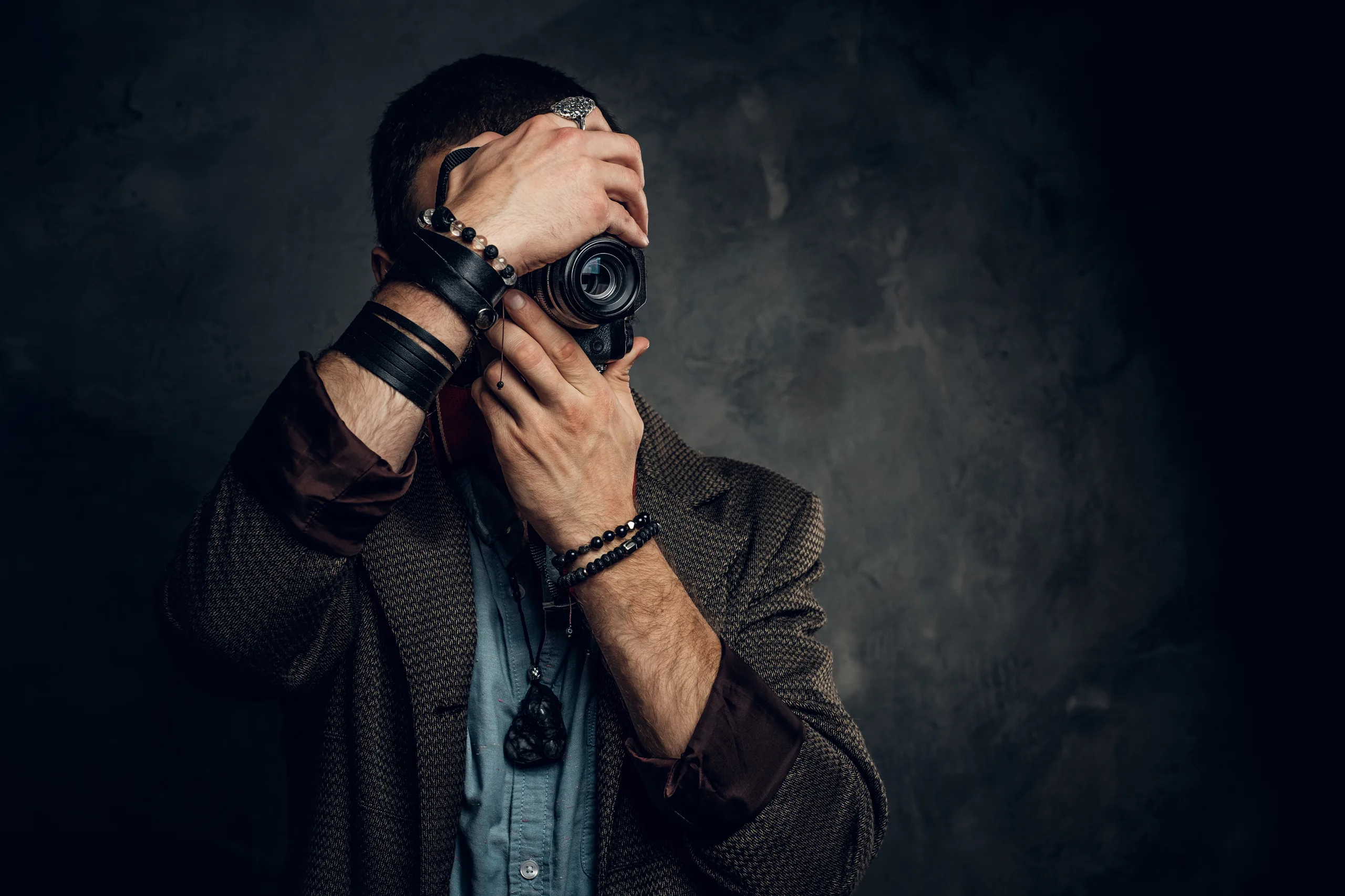 fotógrafo segurando câmera em ambiente escuro