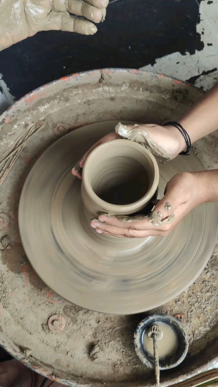 A man playing a drum in front of a group of people