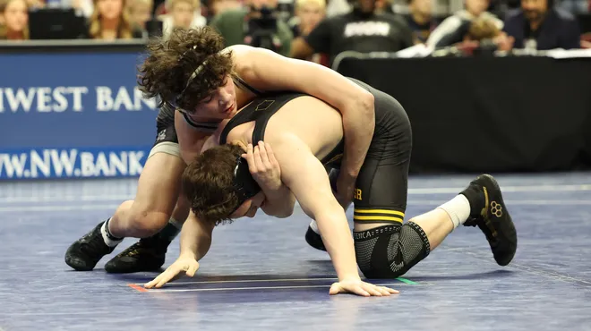 Two young boys wrestling in competition