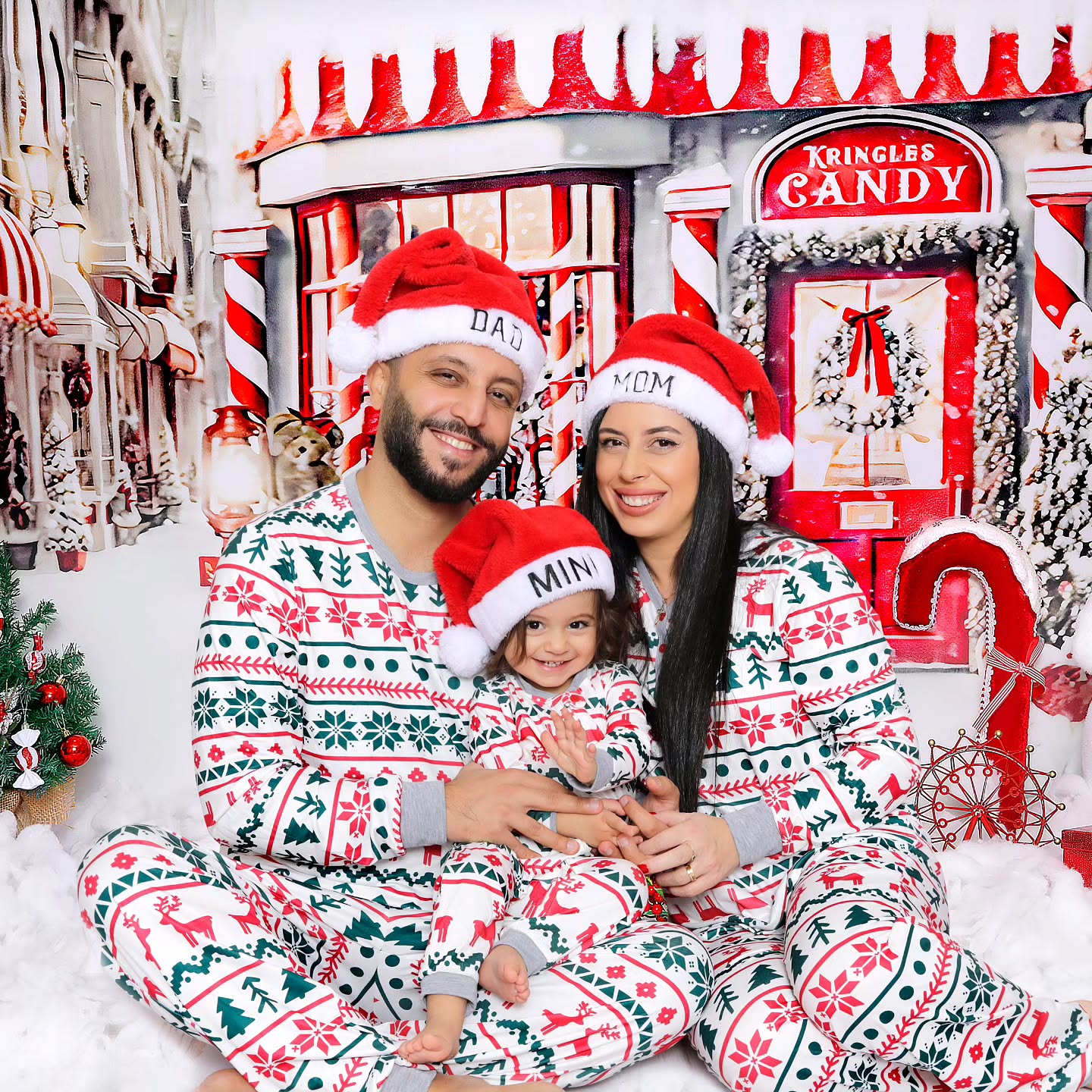 Mahvin Photography Christmas family photoshoot in Dubai featuring a family posing together with their kid for Christmas photos.