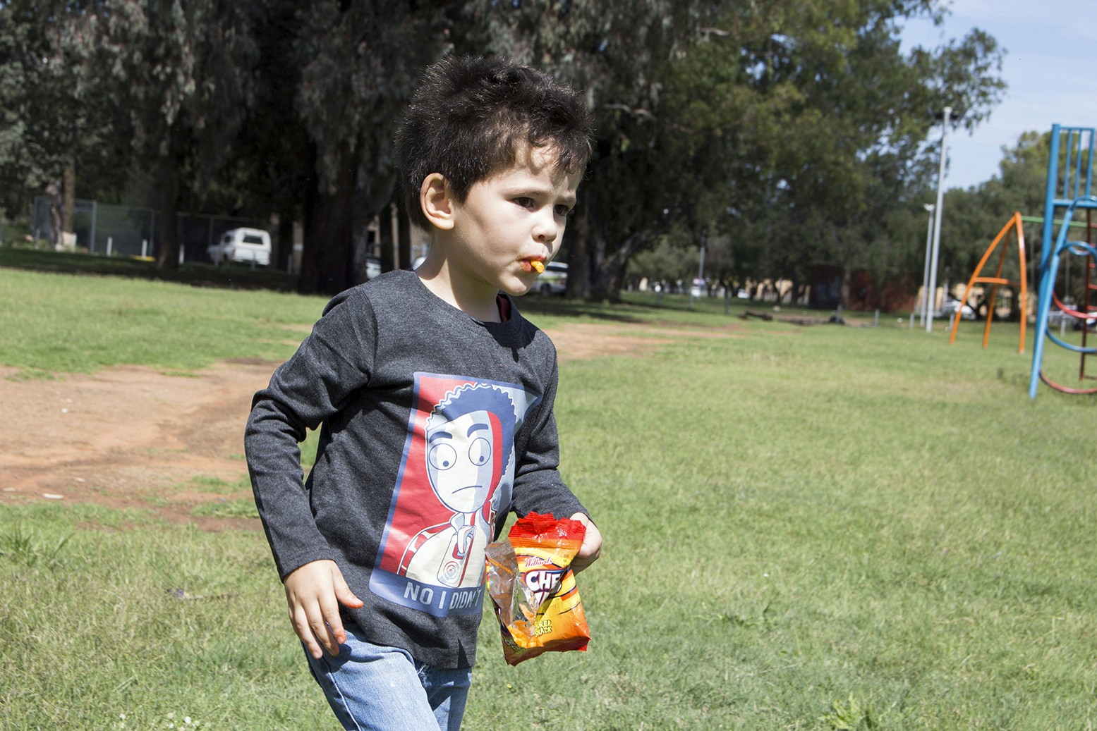 Boy wearing KN Studios merchandise in a playground