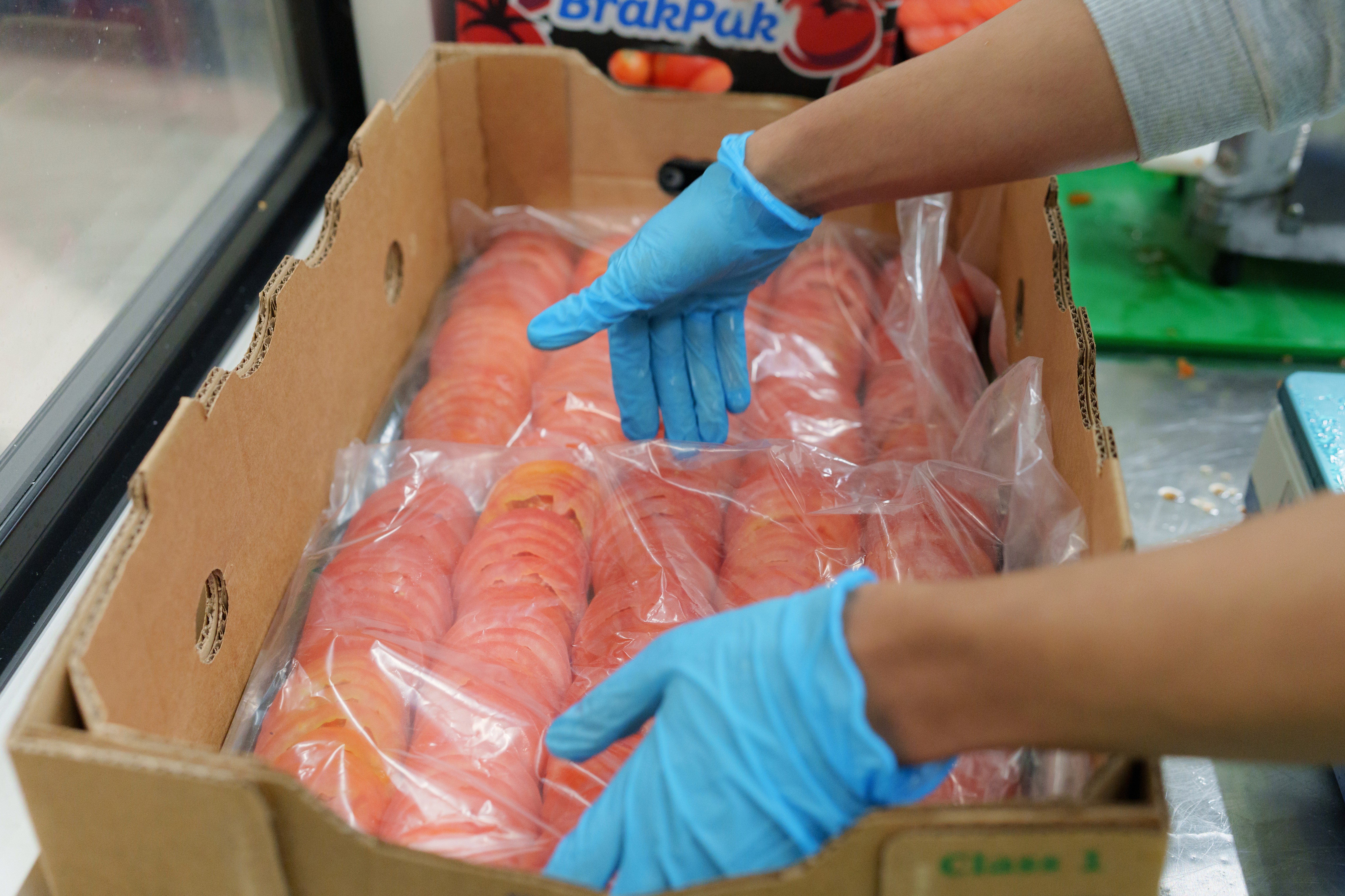 Large logistics warehouse with a worker walking in the center, seen in profile.