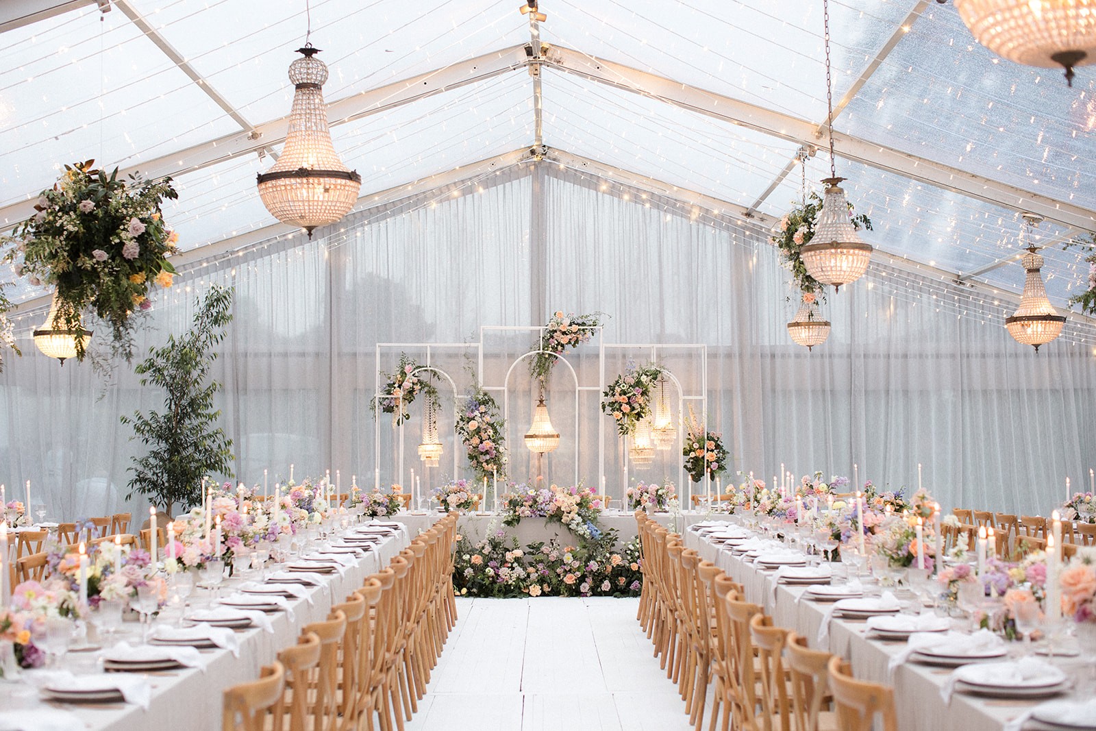 Sit-Down wedding reception set under a clear-roof marquee