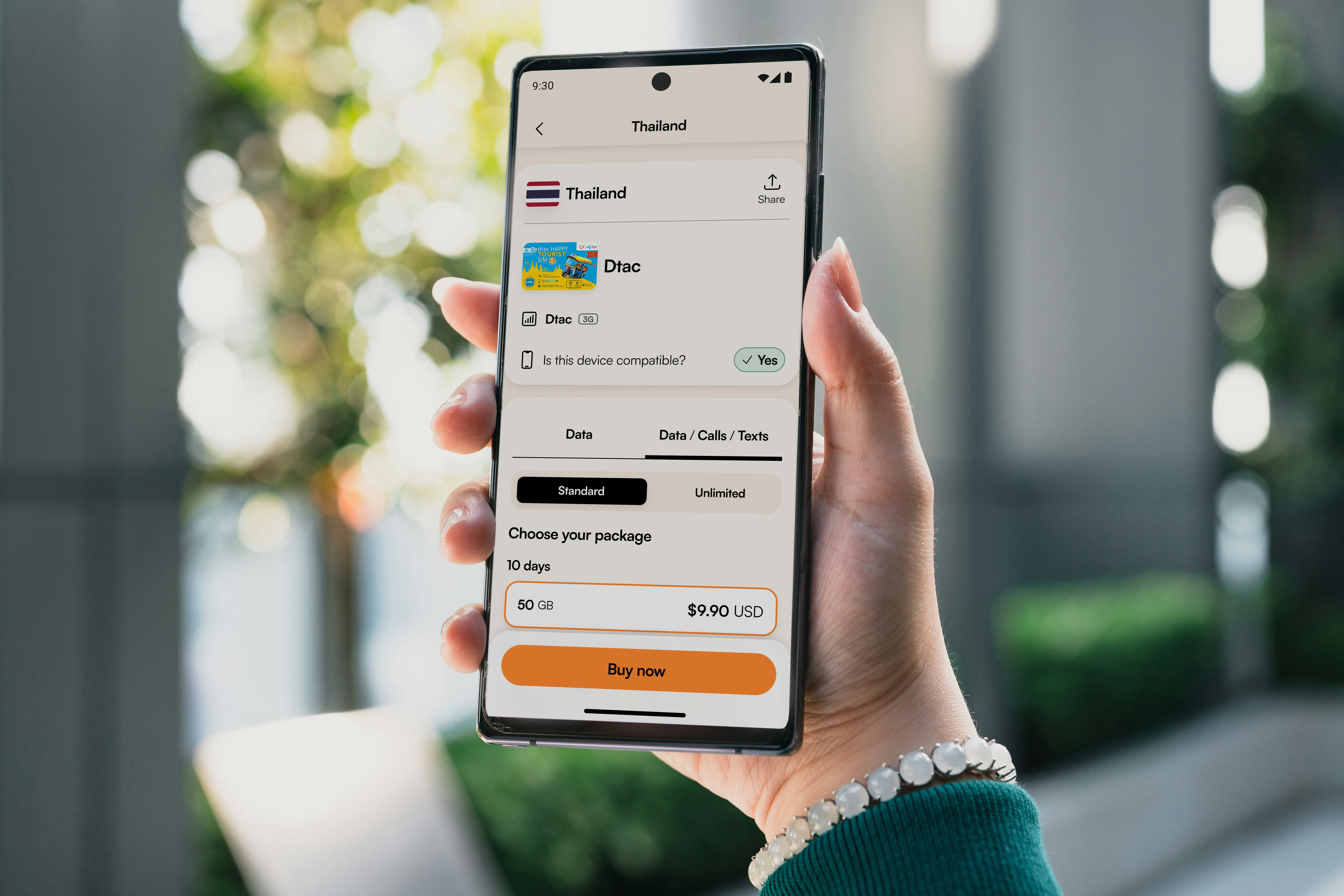 Person holding a smartphone displaying travel booking