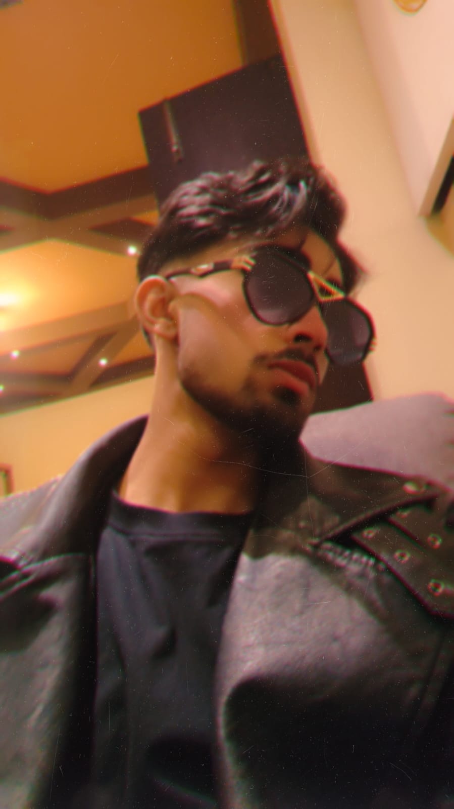 Nischal Poudel in a cool maybatch sunglasses looking sideways