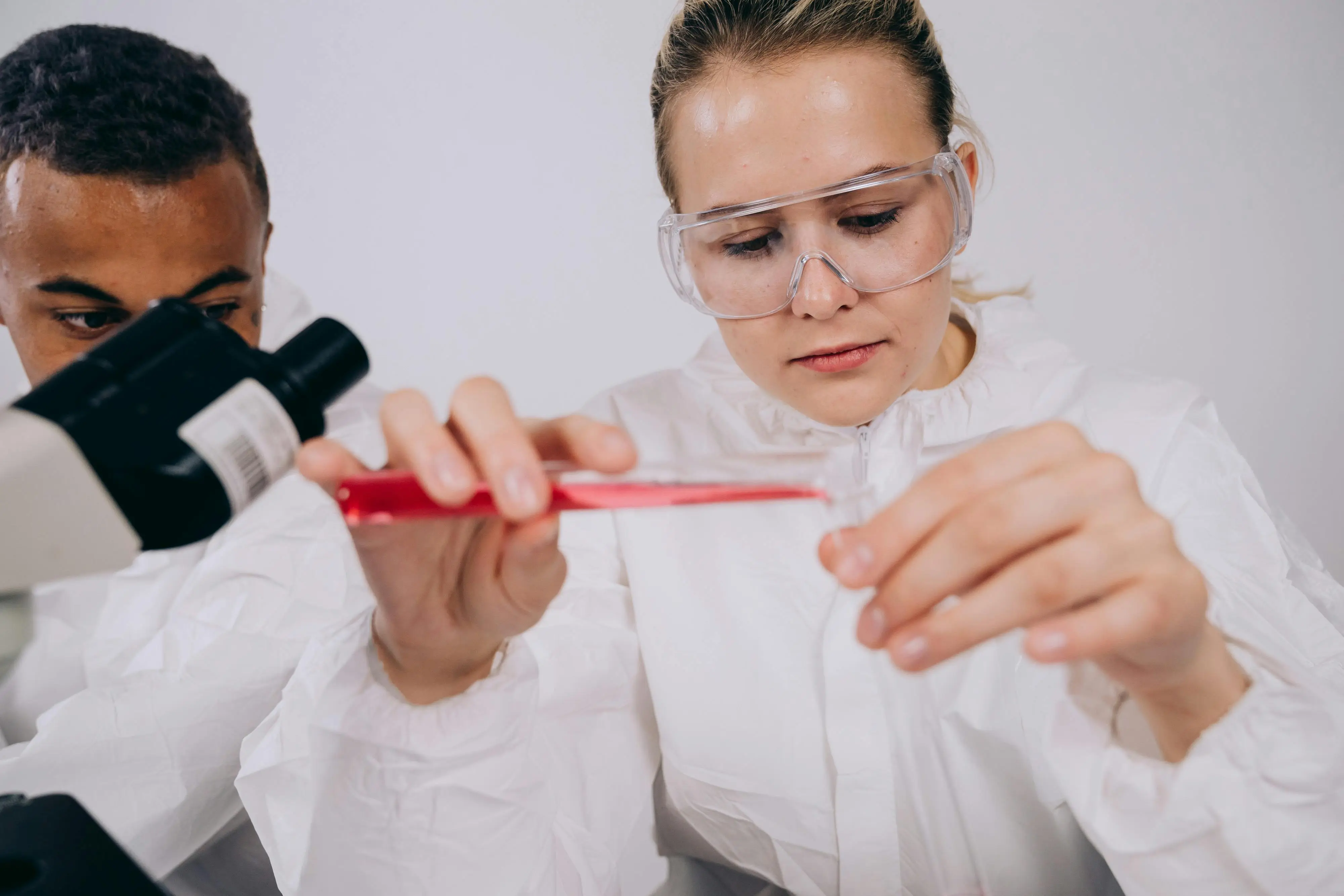 Two people working in a lab. Image from pexels-mikhail-nilov. Why you should get a research internship in high school