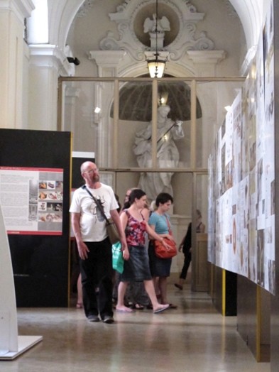 people looking at the photos on the wall