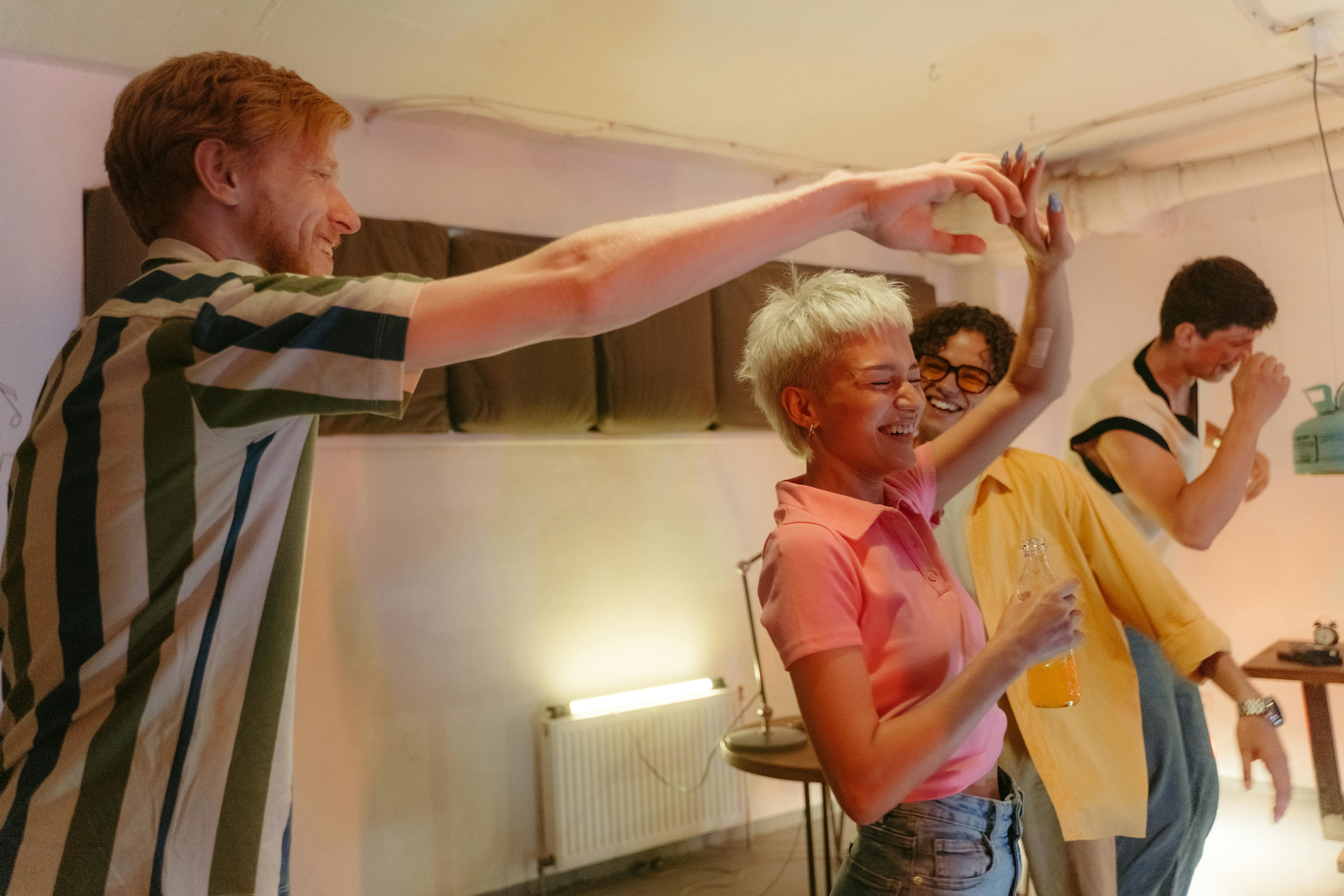 A group of six people poses on a city street, with buildings and shops visible in the background.