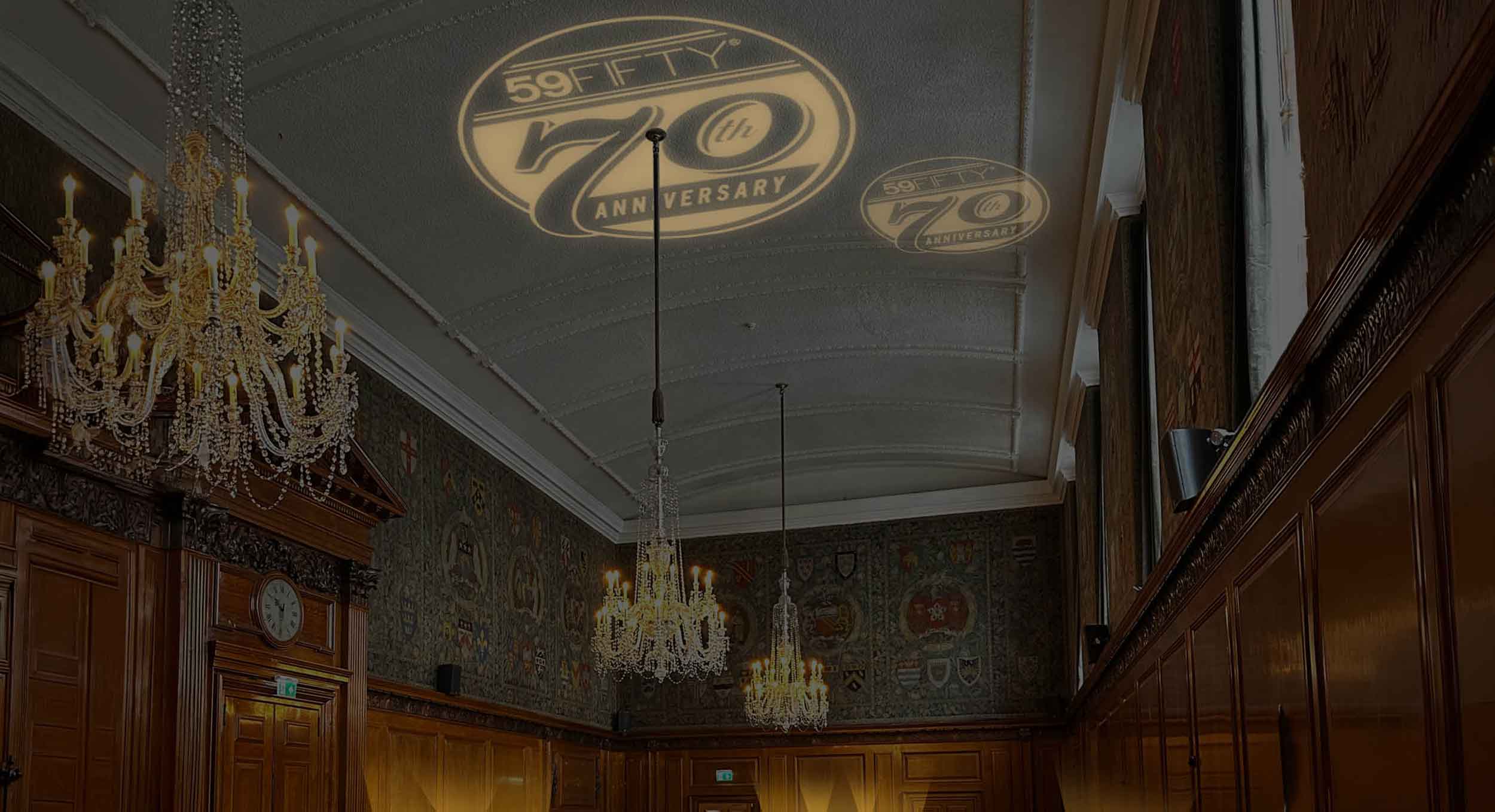render of event interior featuring dramatic lighting, heritage graphics and exhibition-style displays
