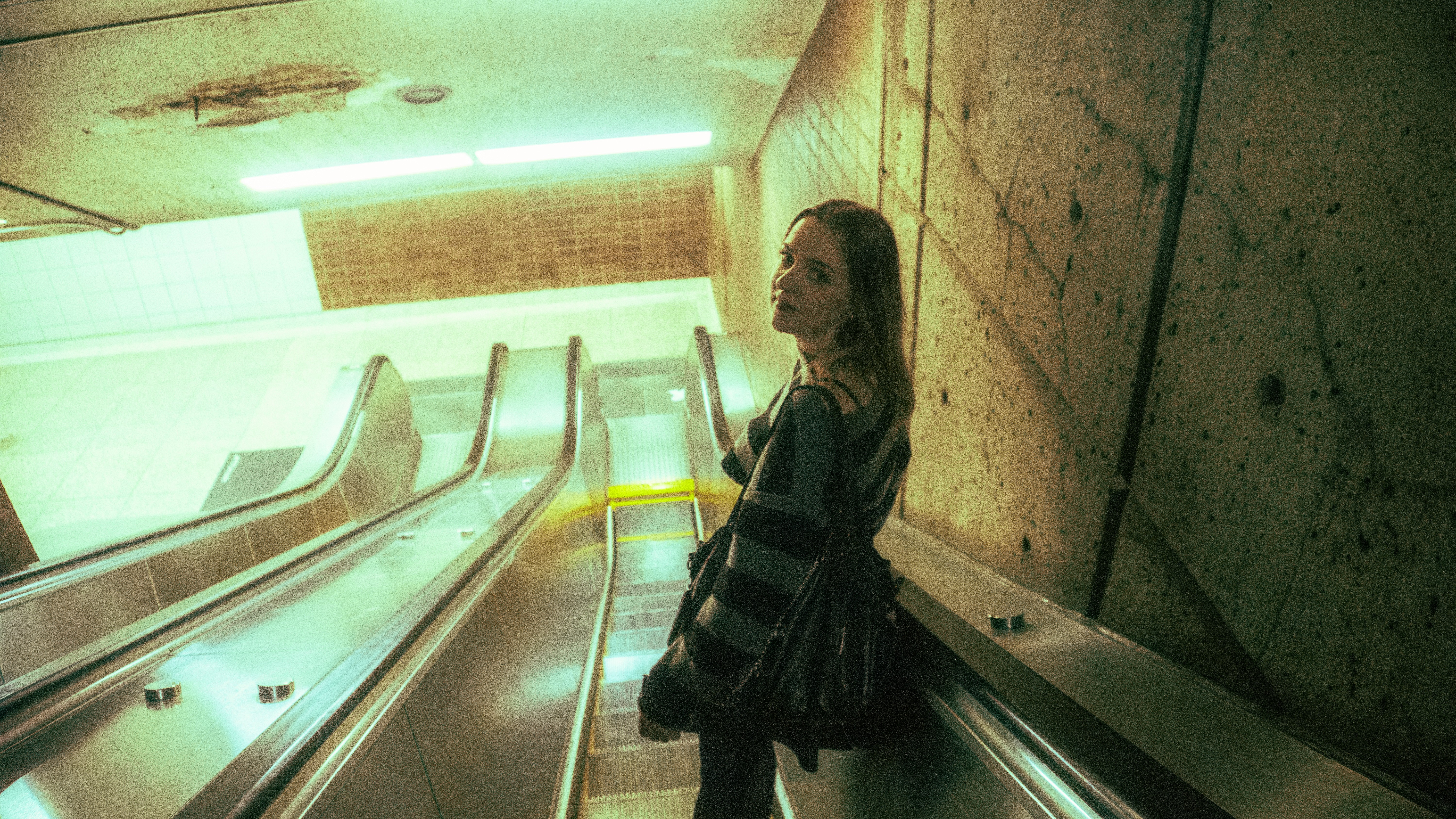 Girl standing on an escalator
