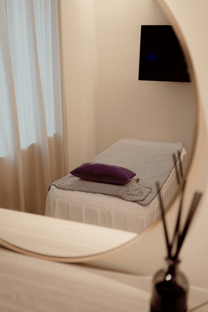 Room with bed and throw pillow.