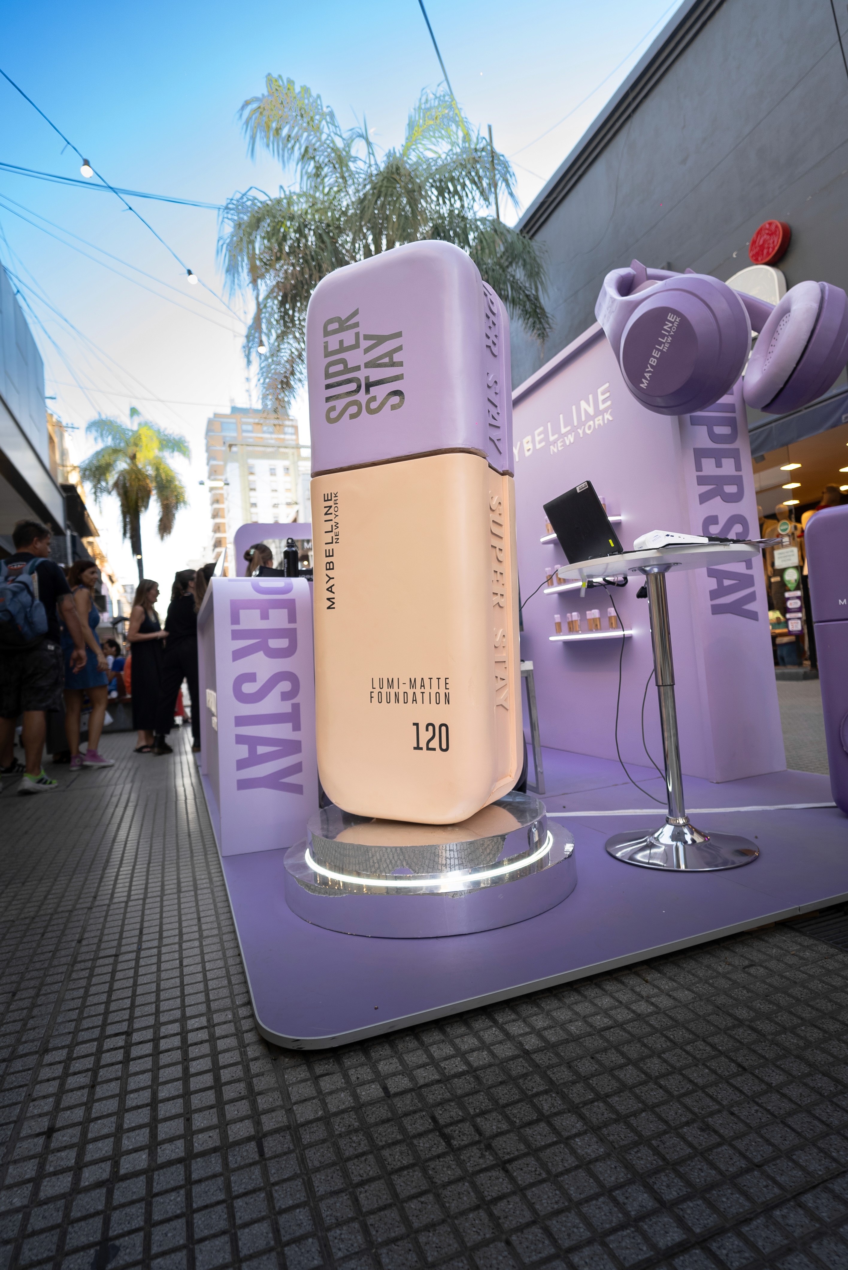 Close-up of a yellow tennis ball sitting on a green court, positioned near the white center line.