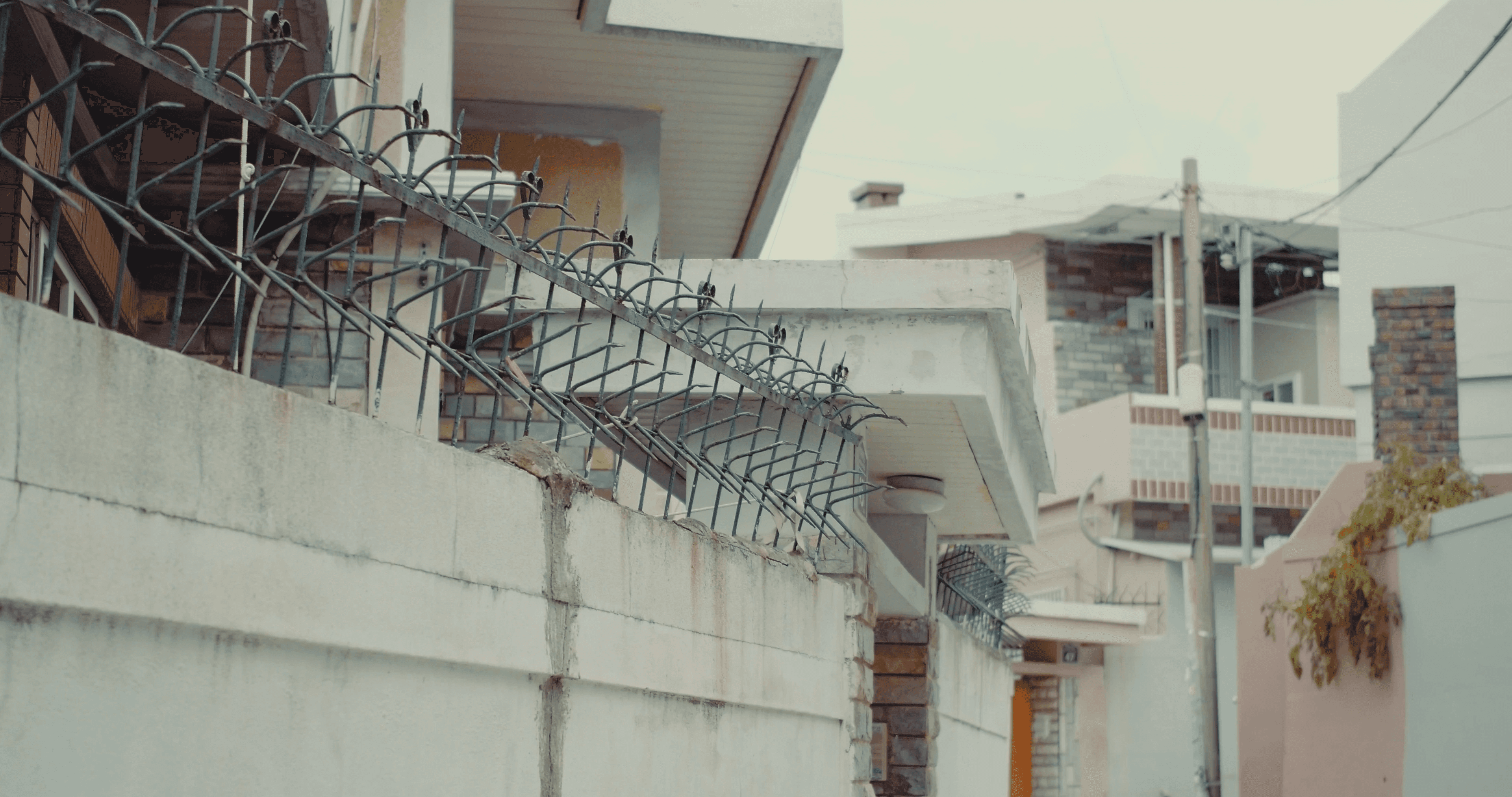 Close-up of model in orange and black outfit behind glass