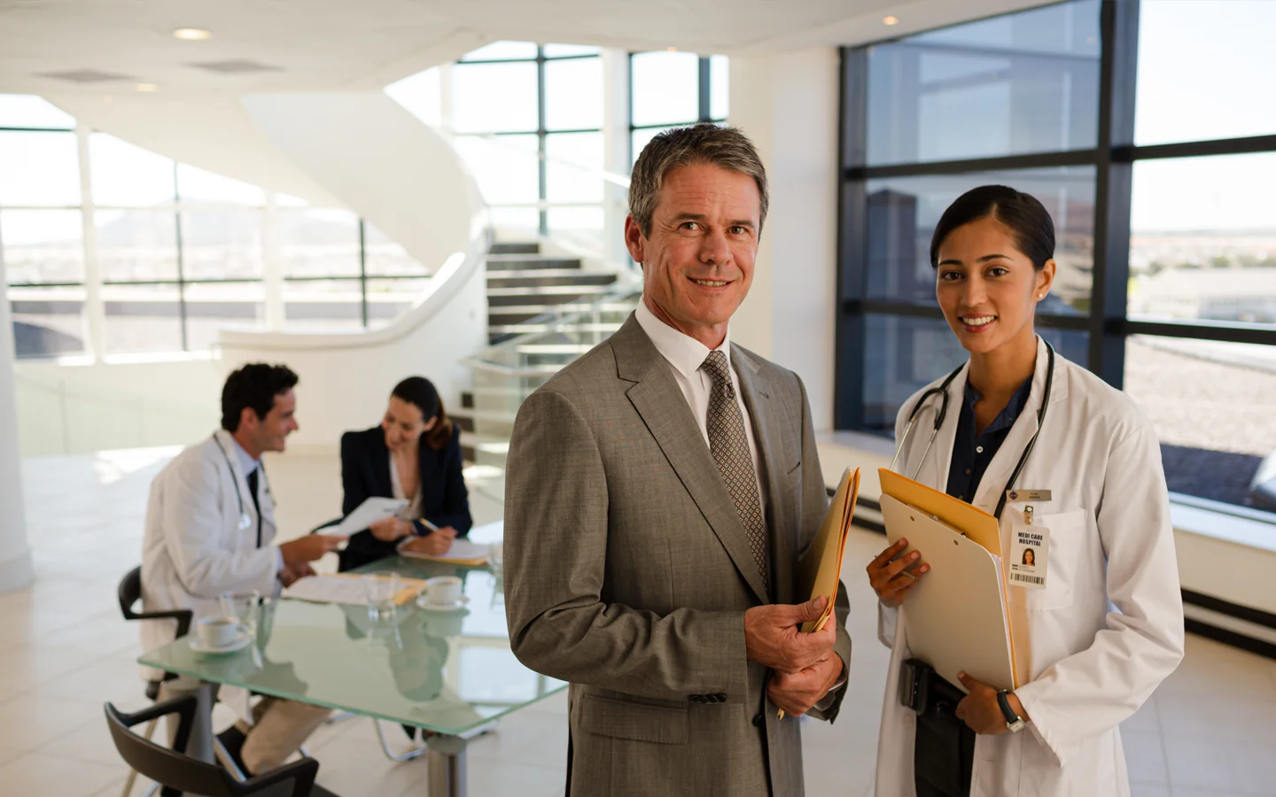 Doctor and hospital executive discussing nurse staffing.