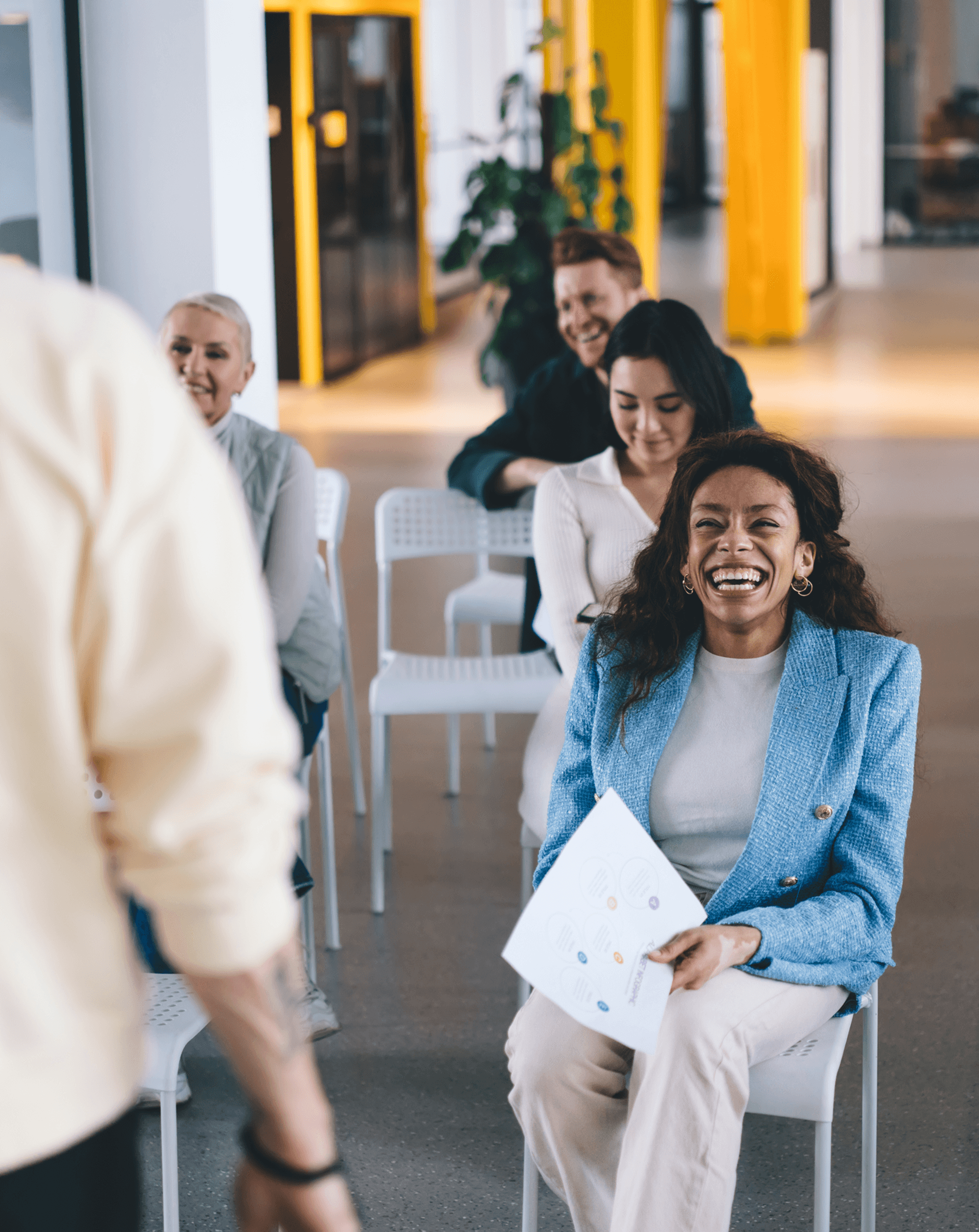 People attending a workshop and laughing during a group session, representing an engaging and positive learning environment.