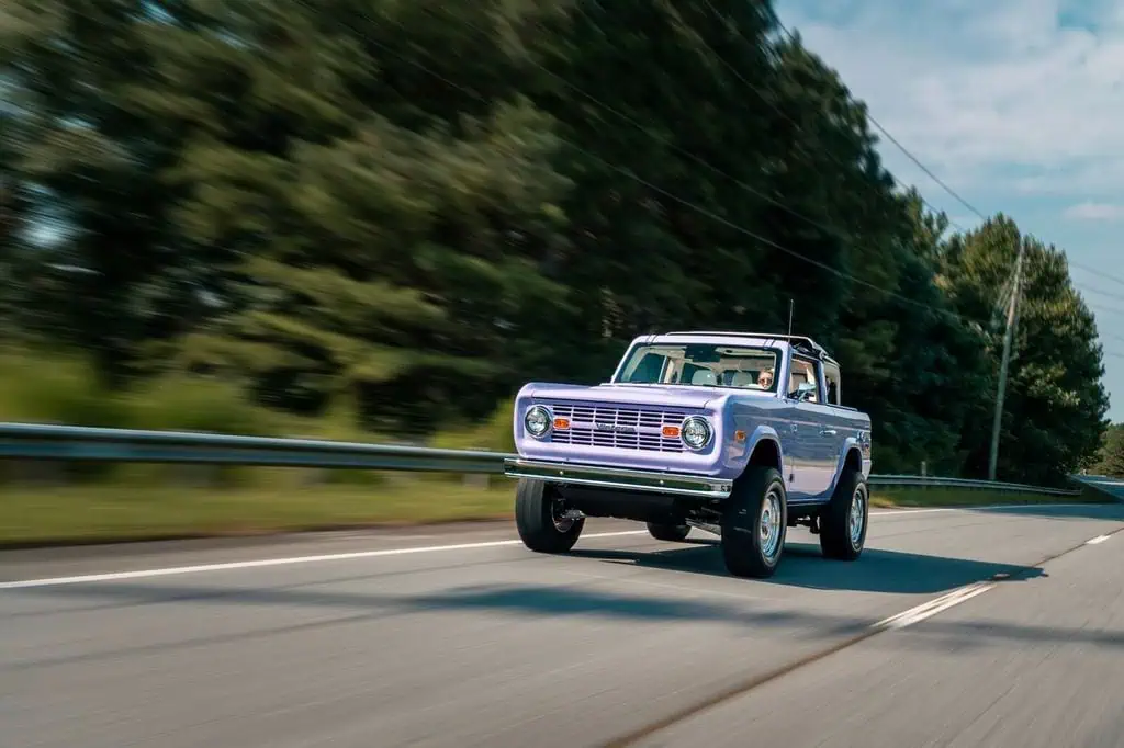 Man with camera near lake and mountains
