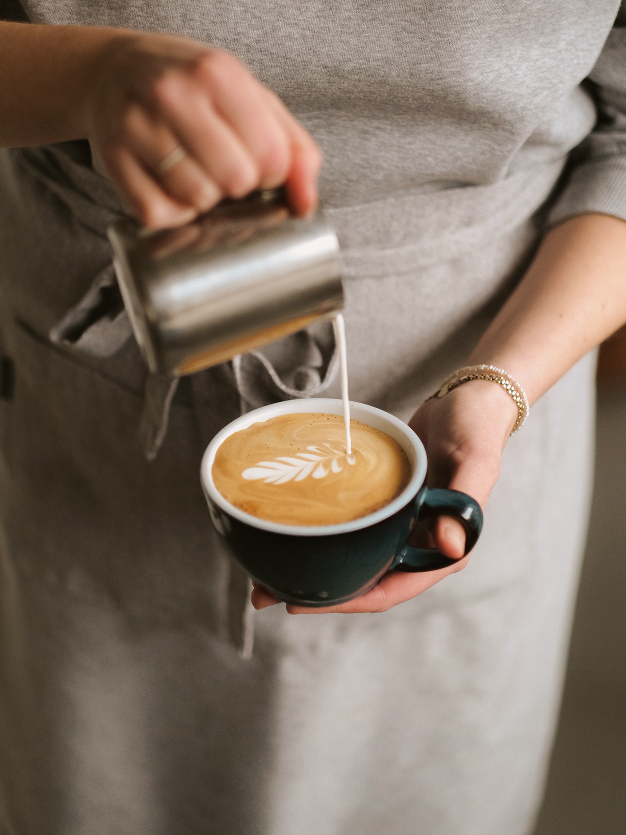 Barista pouring coffee