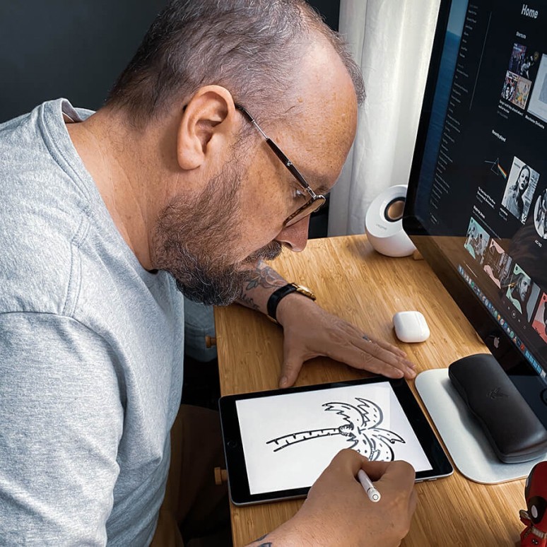 Jonas Strandell sitting at a desk drawing with an Apple Pencil on an iPad
