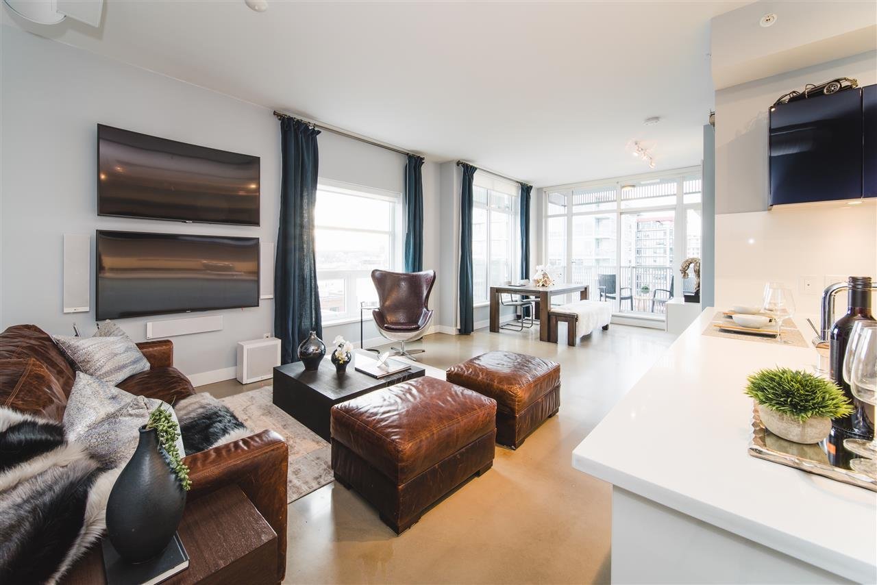 Modern living room featuring brown furniture, large windows, and a bright, airy atmosphere.