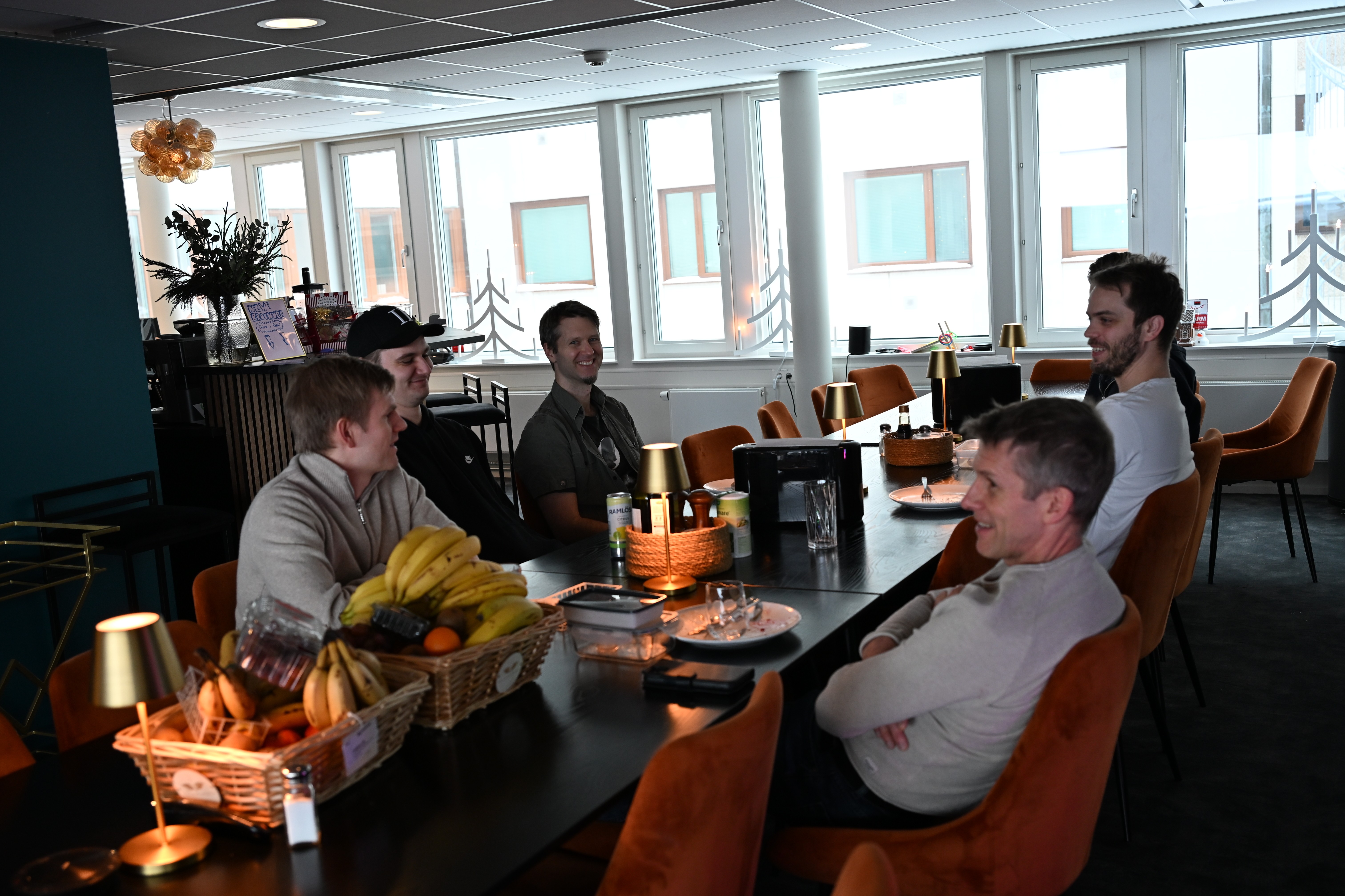 Laptop, tablet, and phone on a wooden desk.