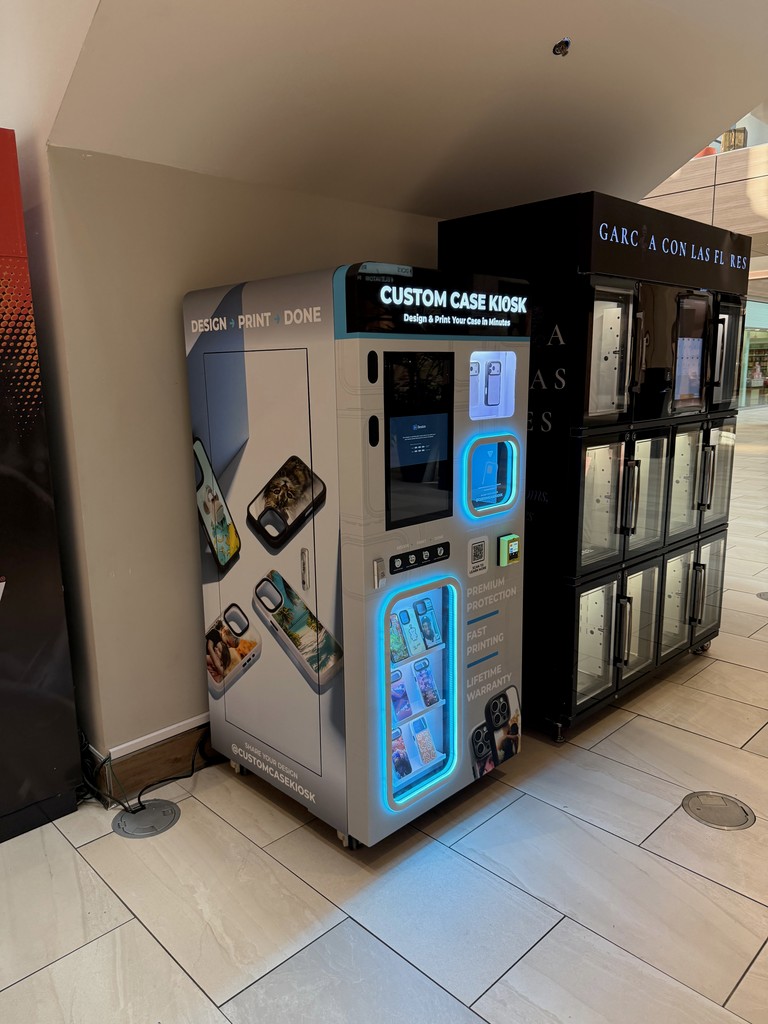 Custom Case Kiosk at Rosedale Center mall in Roseville, MN with illuminated display and touchscreen for on-demand custom phone case printing.