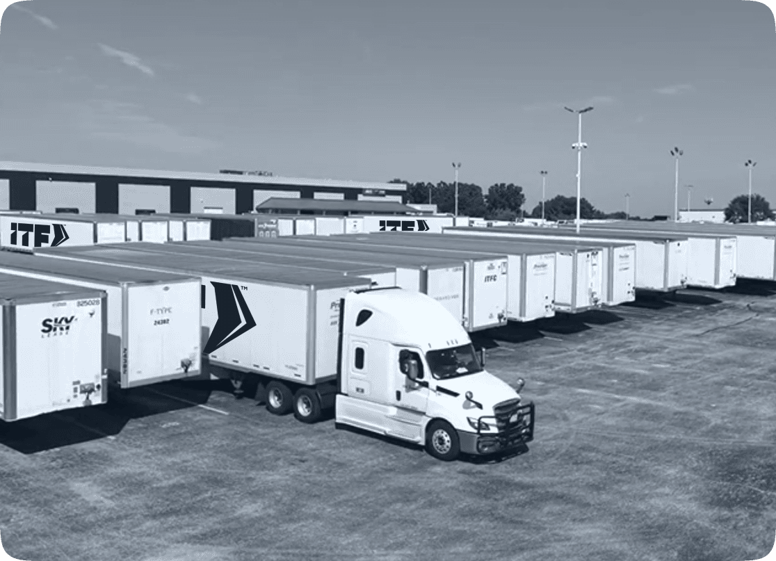ITF Group’s white semi-truck prepares for full truckload shipping alongside a row of freight carriers at its St. Louis logistics hub.