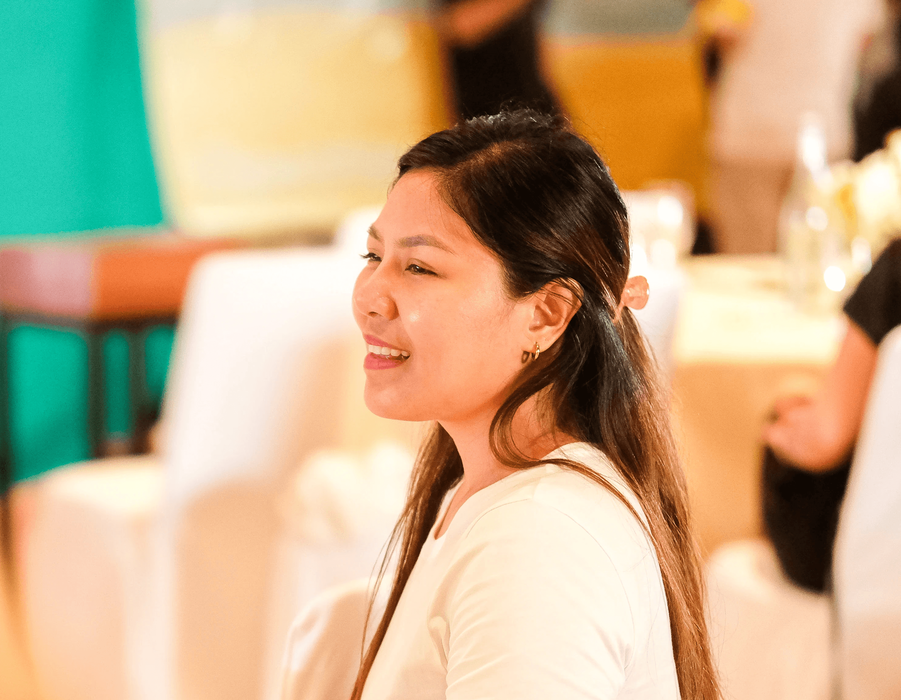 A small photo of a young woman smiling.