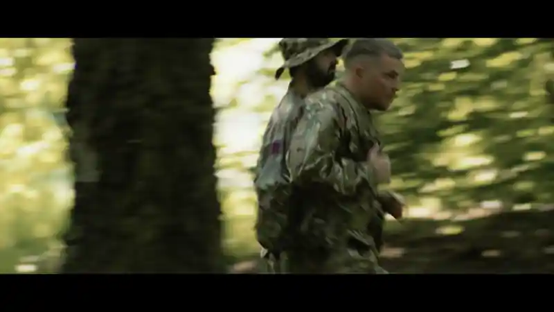 Group of presenters speaking on camera during a Microsoft live broadcast, filmed against branded event graphics.