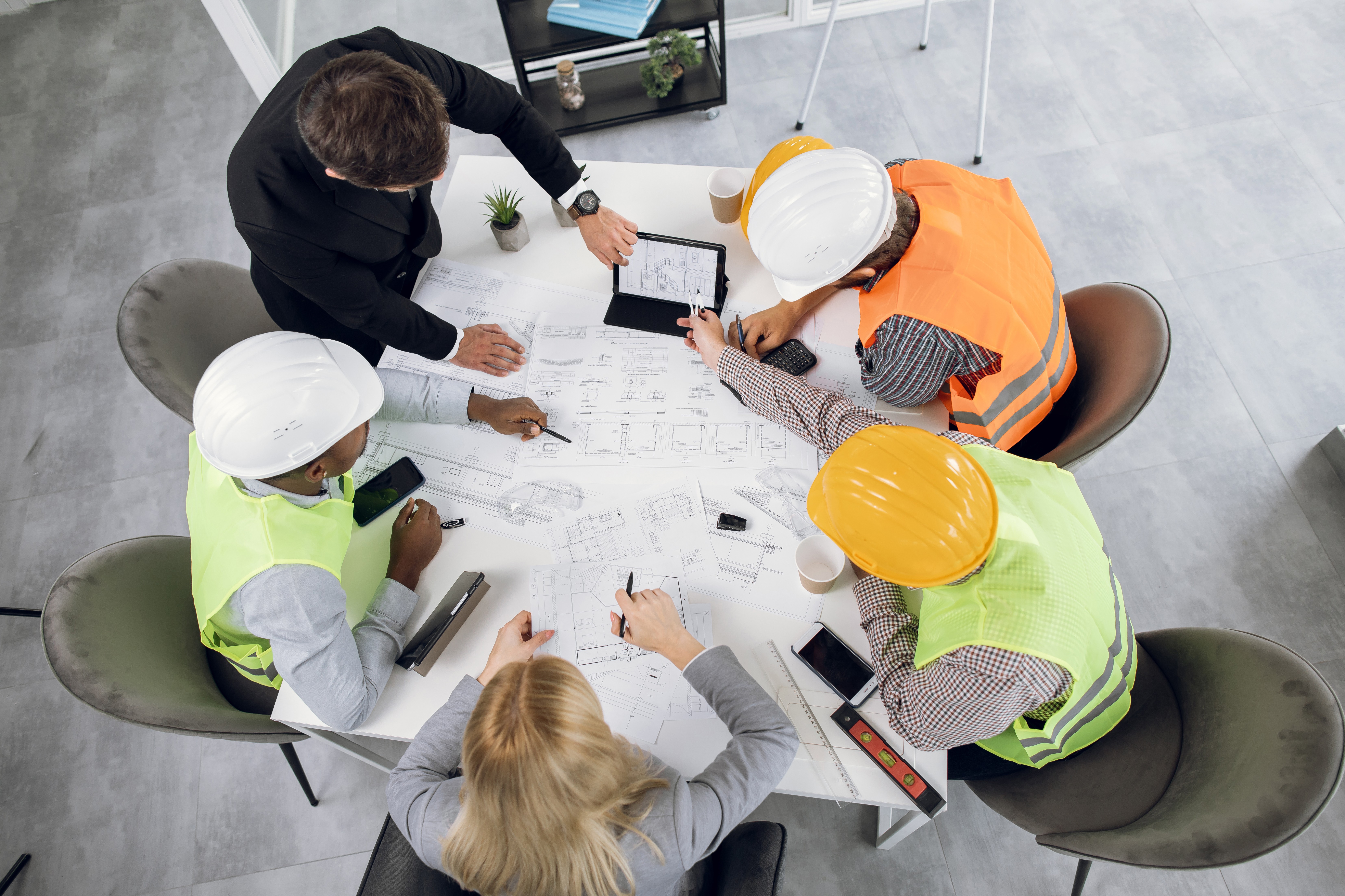 Construction team reviewing project plans, representing construction marketing, construction digital marketing, and marketing for construction companies.