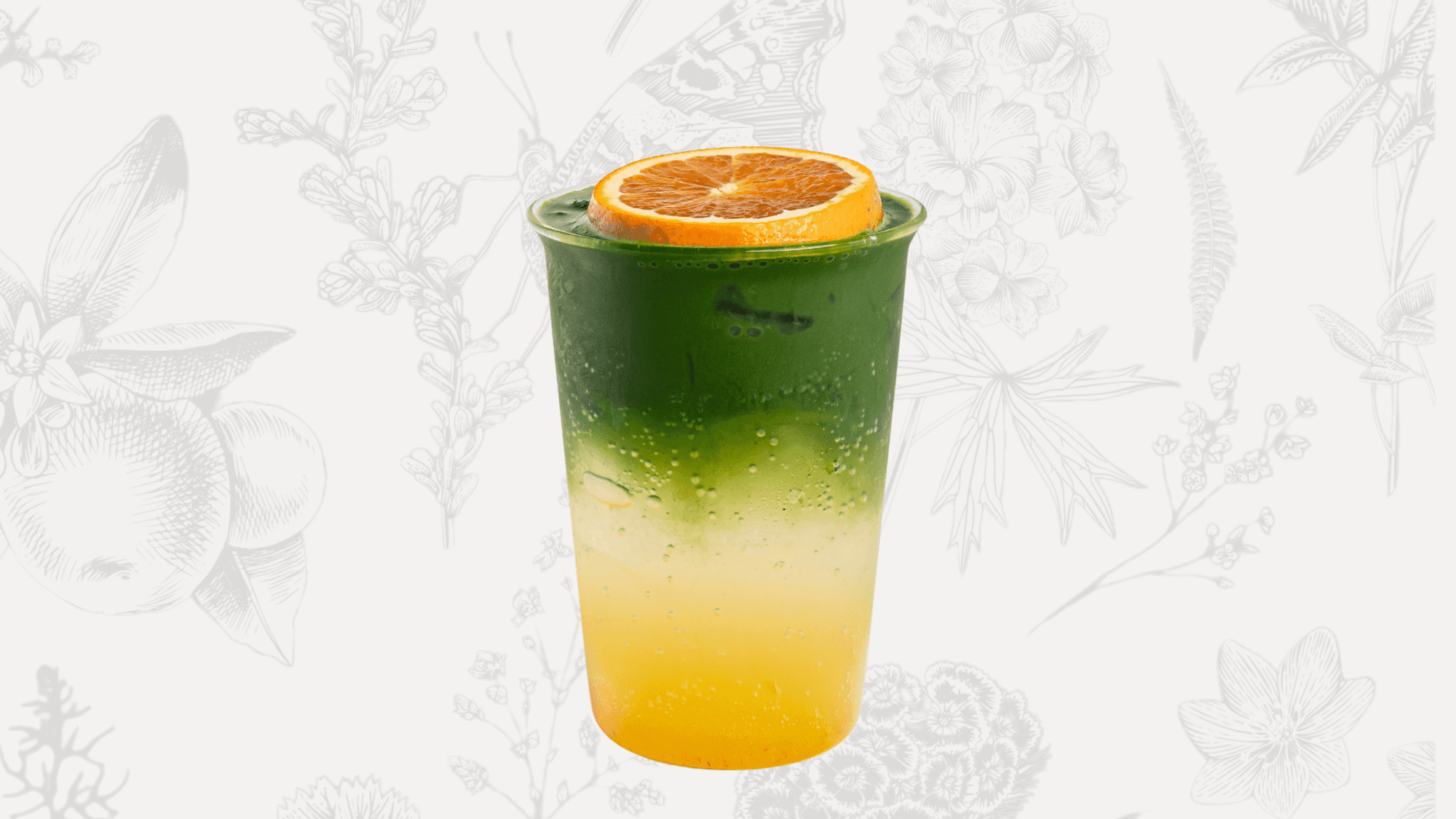 Orange Matcha Tonic – A sparkling drink made with orange jam and tonic water, served with a fresh orange slice garnish.